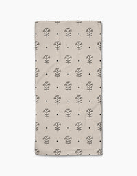 The Cole Strem Inked Bloom Bar Towel is beige and rectangular, featuring a grid of black line-drawn flowers and dots. Crafted from Geoweave fabric, it offers exceptional durability and absorbency.