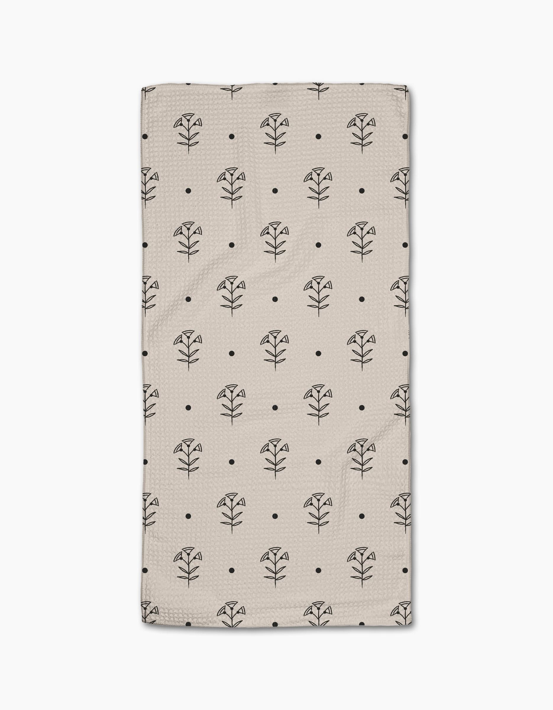 The Cole Strem Inked Bloom Bar Towel is beige and rectangular, featuring a grid of black line-drawn flowers and dots. Crafted from Geoweave fabric, it offers exceptional durability and absorbency.