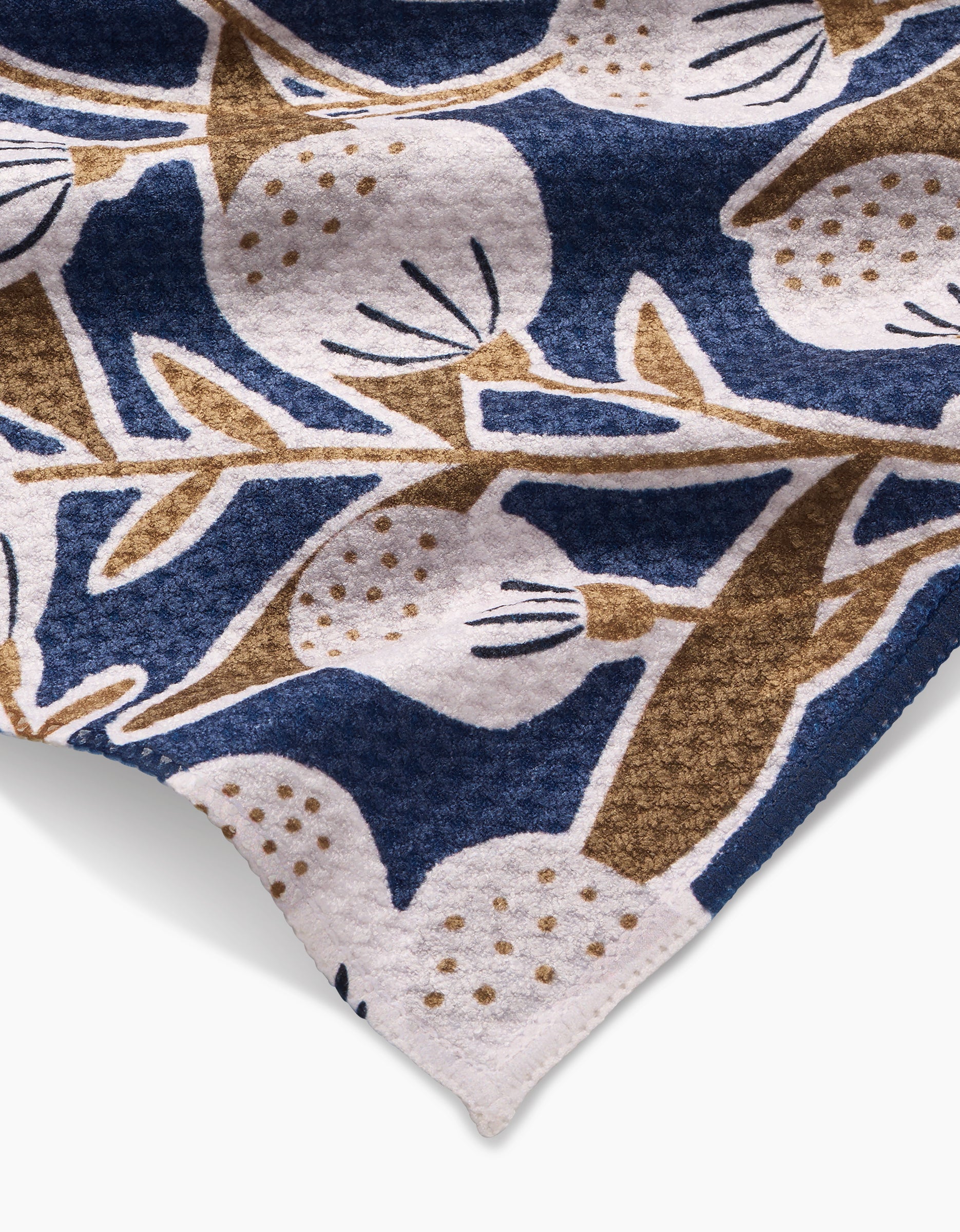 A close-up of the Leslie Bar Towel by Amy MacCready, made from Geoweave fabric and featuring abstract blue, brown, and white botanical patterns with round fruit and leaf motifs.