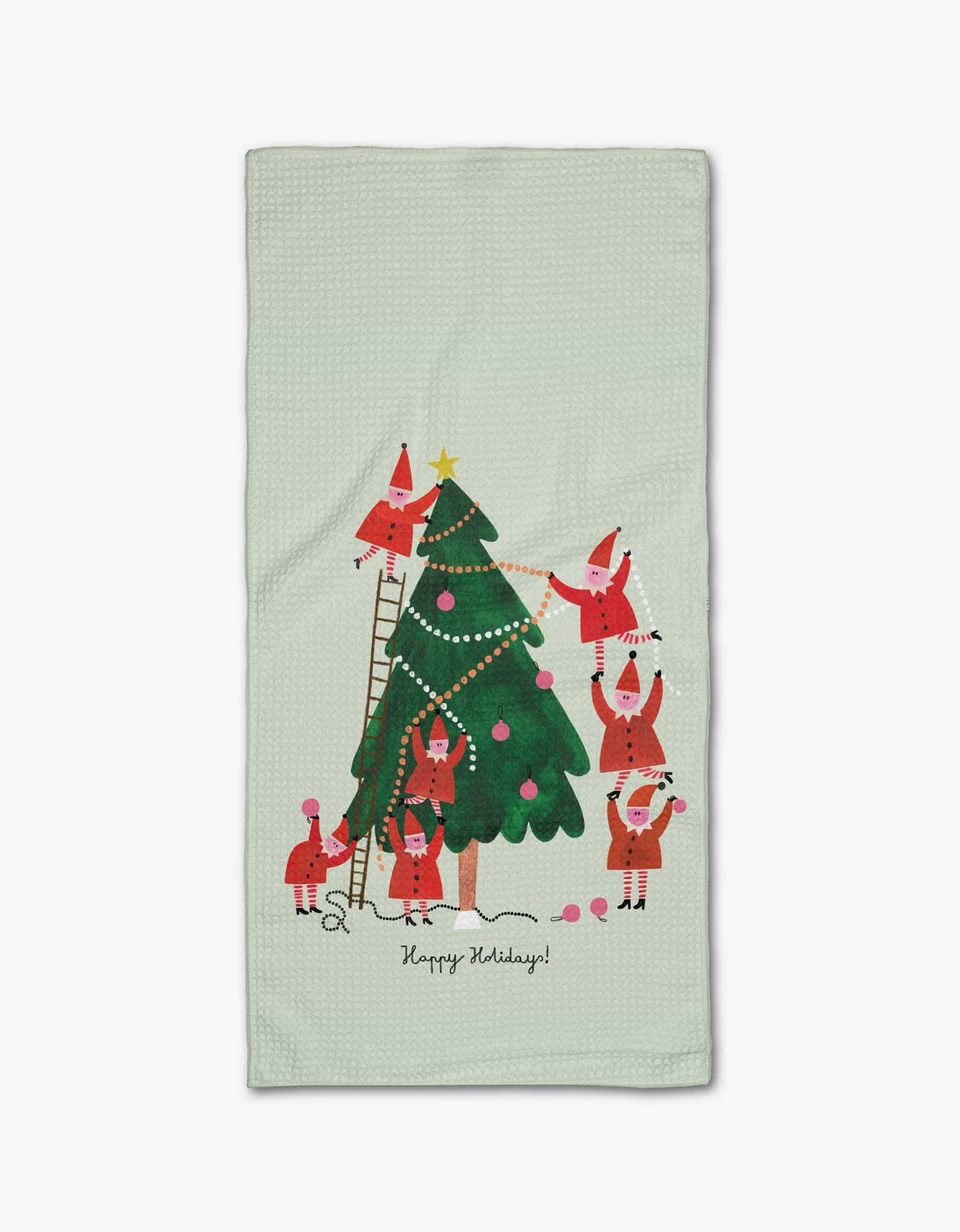 “Little Helpers” by Daria Solak: Six cartoon Santas decorate a Christmas tree with garland, ornaments, and a star. Some stand on ladders, others hold decorations. Printed on recycled Geoweave™ fabric. “Happy Holidays!” appears below the tree.