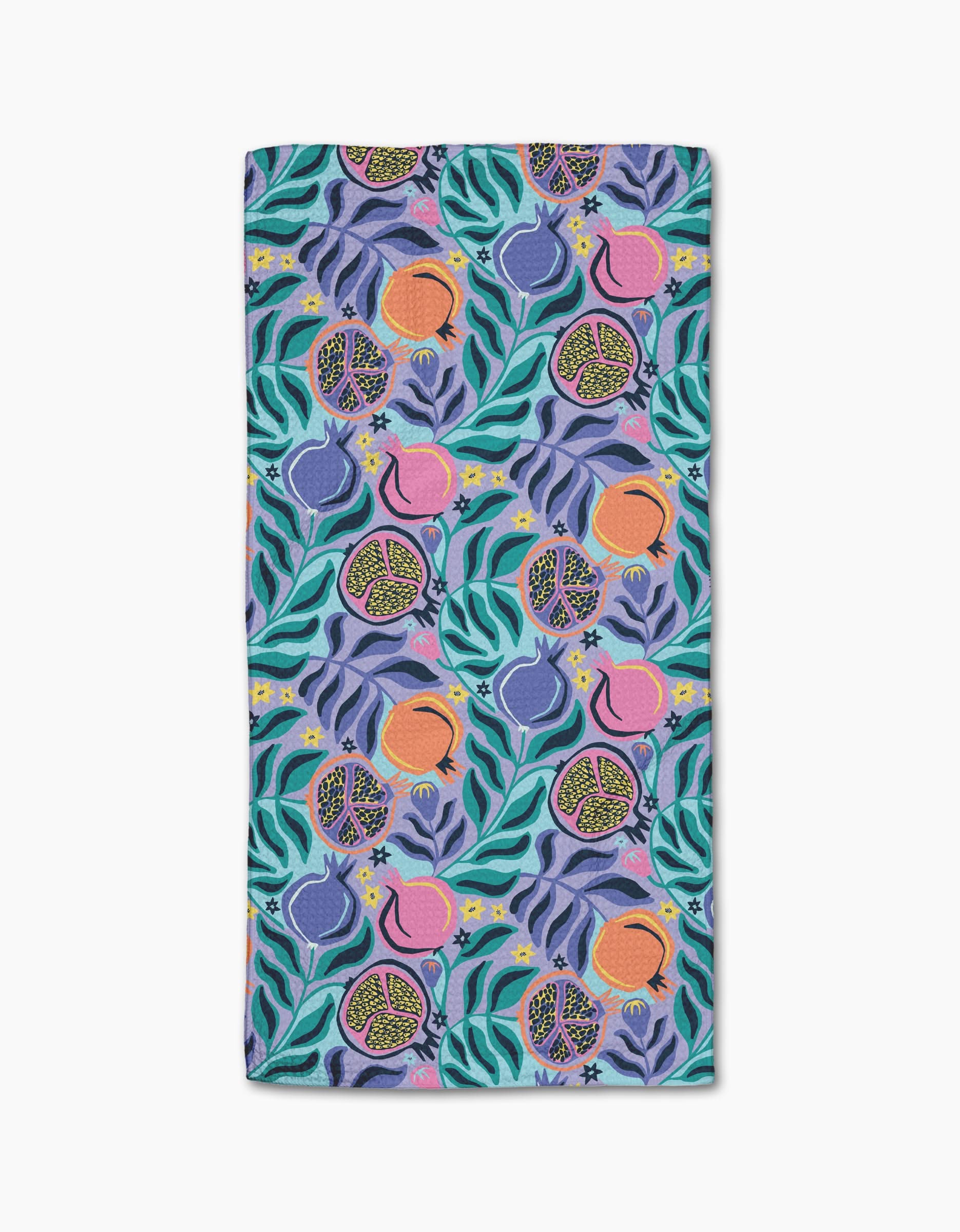 The Lucky Pomegranate Bar Towel by Masha Volnova features vibrant pomegranates, flowers, and leaves in purple, pink, blue, green, and orange on a light purple background. Made from recycled materials.