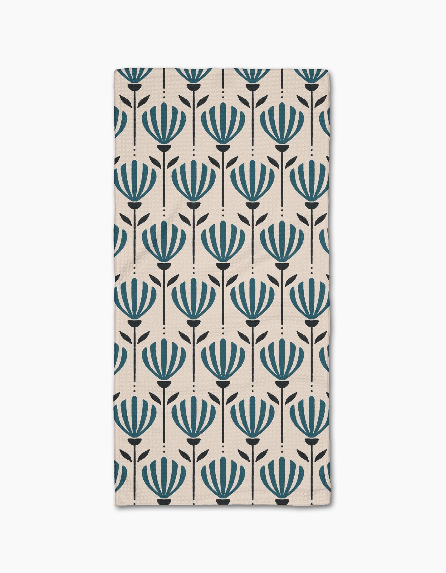 The Martine rug by Amy MacCready is a rectangular beige piece with evenly spaced rows of stylized blue flowers and black stems, crafted from recycled materials for an eco-friendly touch.