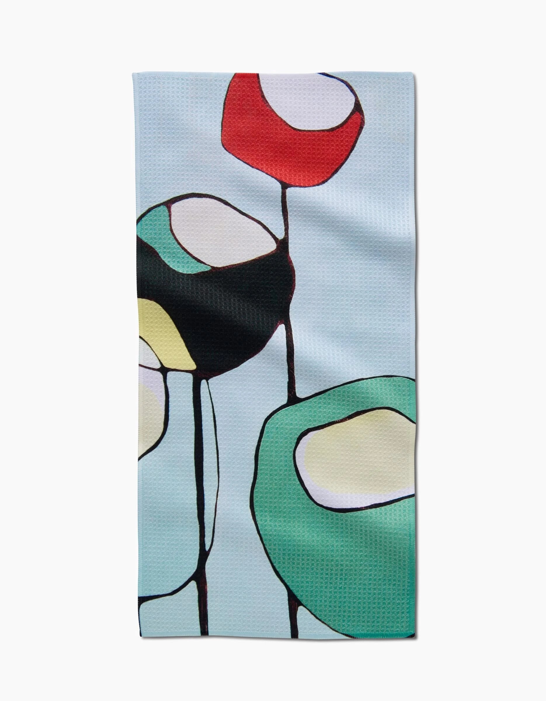The Modern Poppy bar towel by Rachel Austin features large, colorful abstract flower shapes in red, green, yellow, and black on a light blue Geoweave fabric.