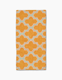 The Mustard Ogee by Pascale Dilger is a rectangular, ultra-absorbent towel featuring a bold orange geometric pattern with interconnected shapes outlined in light blue and white on a plain white background.