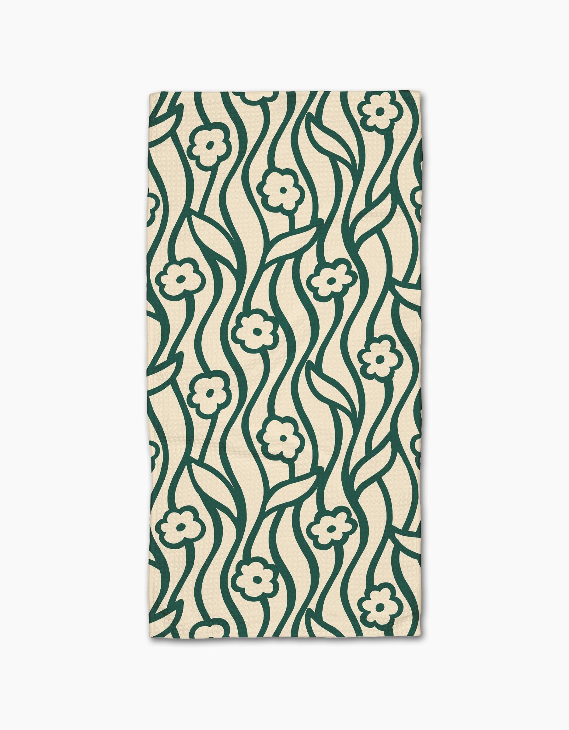 The Nostalgic Flowers kitchen towel by Gerdadzy is a rectangular beige recycled napkin featuring a dark green wavy floral pattern with small flowers and stems, symmetrically repeated across the fabric.
