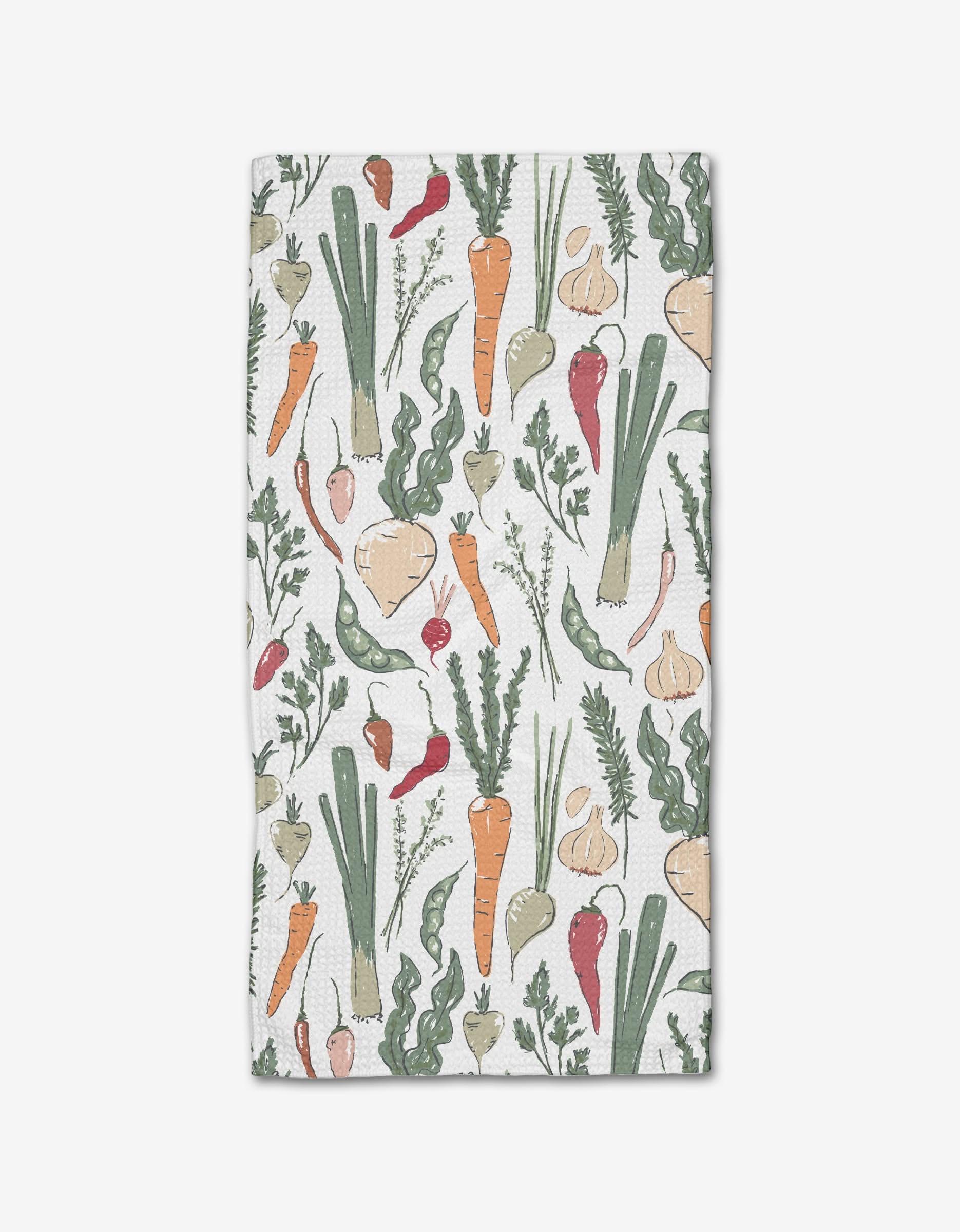 The Organic Vegetable kitchen bar towel by Hufton Studio features hand-drawn veggies—carrots, leeks, turnips, garlic, radishes, and peas—on a white background and is made with absorbent Geoweave fabric.