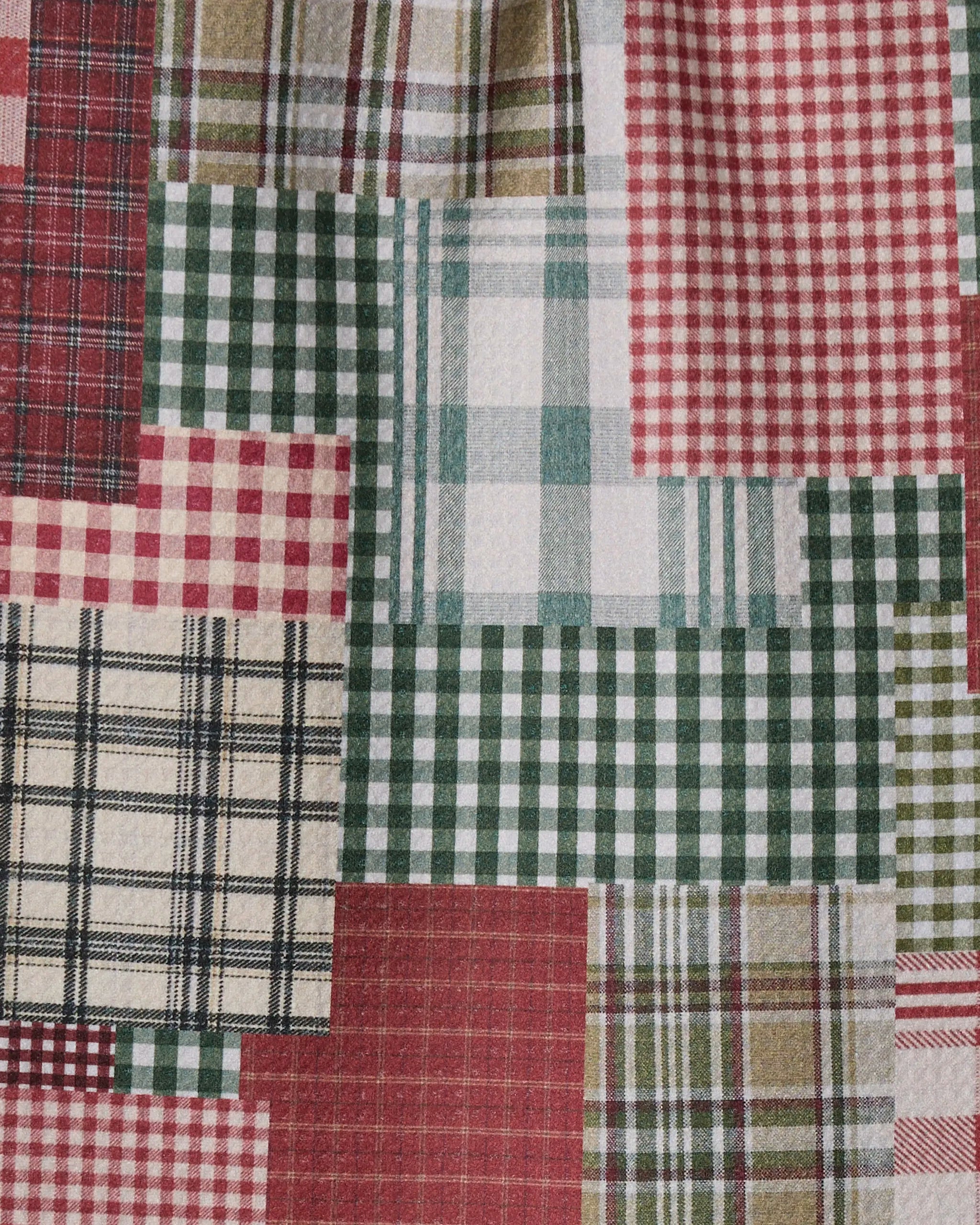 Patchly by Geometry features a close-up of recycled patchwork fabric with red, green, beige, and cream plaid and checkered patterns. The stitched design creates a textured, quilt-like look.