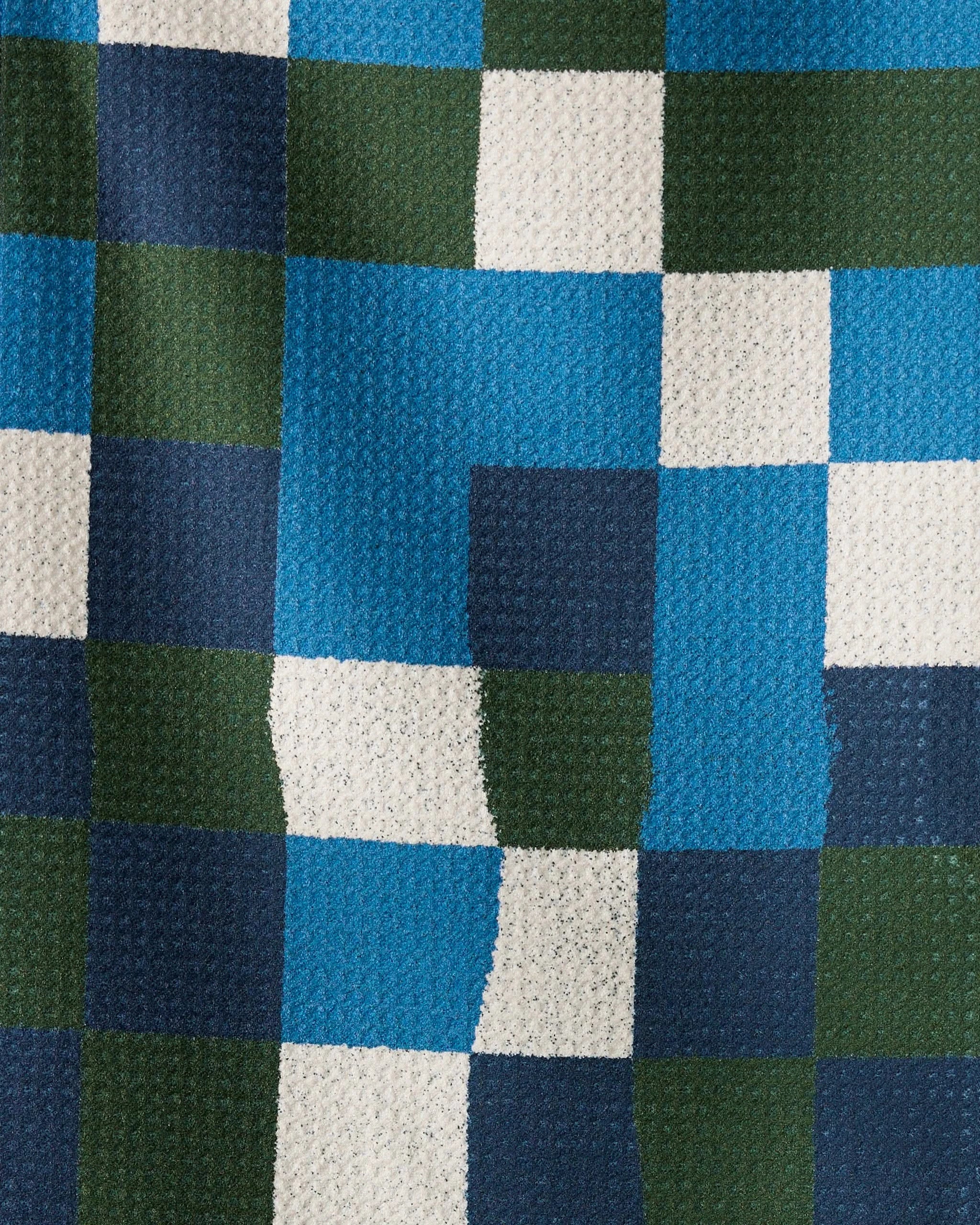 The Patchpoint towel by Geometry features a textured checkered design in blue, green, navy, and white—ultra-absorbent and ideal for your kitchen or bar.