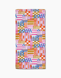 The Playful Stripes rug by Claire Iglesias features an abstract geometric pattern in pink, orange, blue, red, and white on a plain background. Made from recycled materials, it showcases stripes, checks, and blocks.