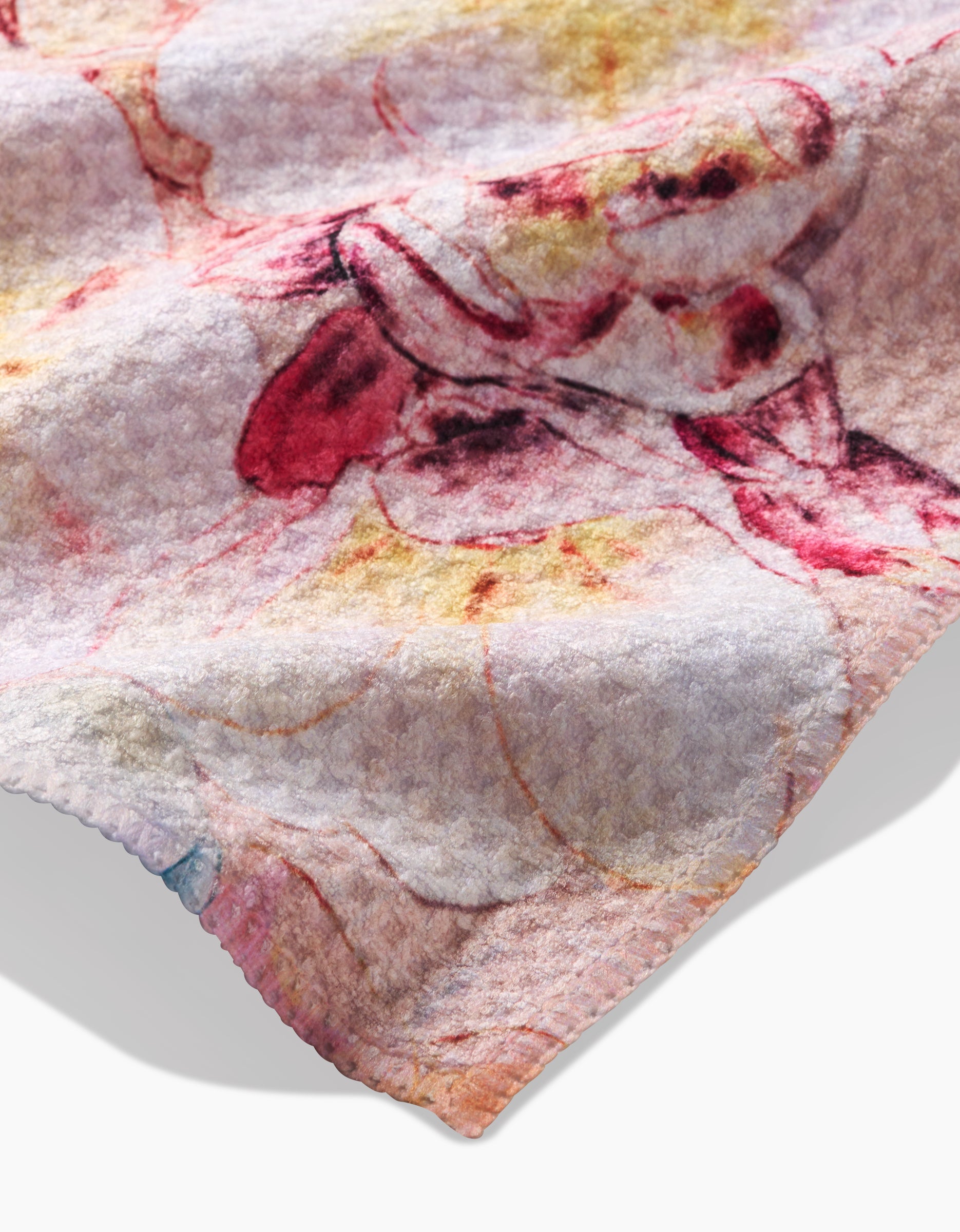A close-up of Pascale Dilger’s Primroses shows soft, textured Geoweave fabric with pastel pink, red, and yellow floral prints on a light background and a subtle wavy edge.