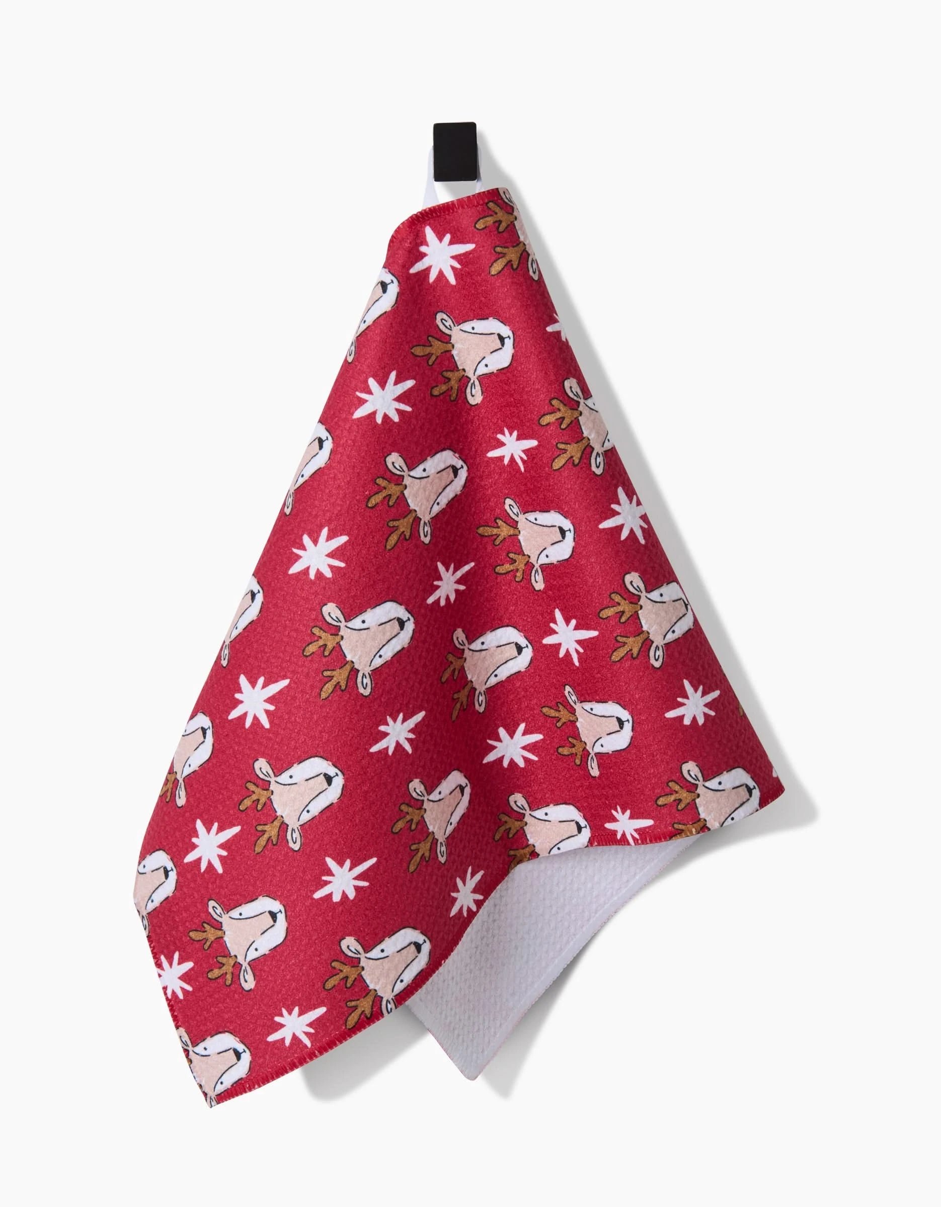 The Hufton Studio Reindeer Star towel features a red ultra-absorbent front with white reindeer faces, antlers, and scattered snowflakes, a textured white underside, and hangs from a black loop.