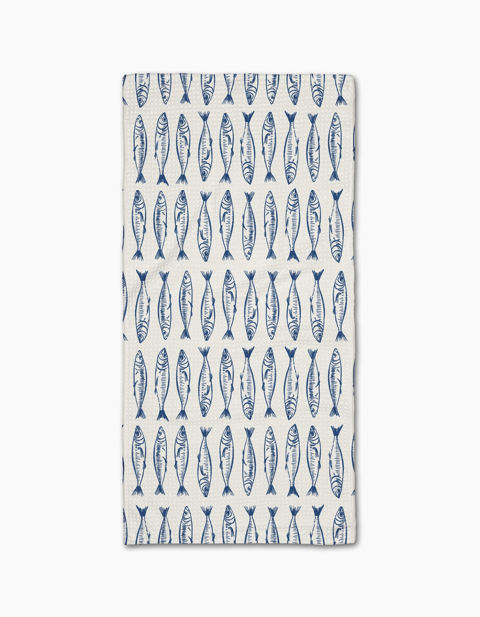 The Sardine Stripes Blue Bar Towel by Hufton Studio is white and rectangular, featuring neat rows of blue fish and crafted from durable Geoweave fabric.