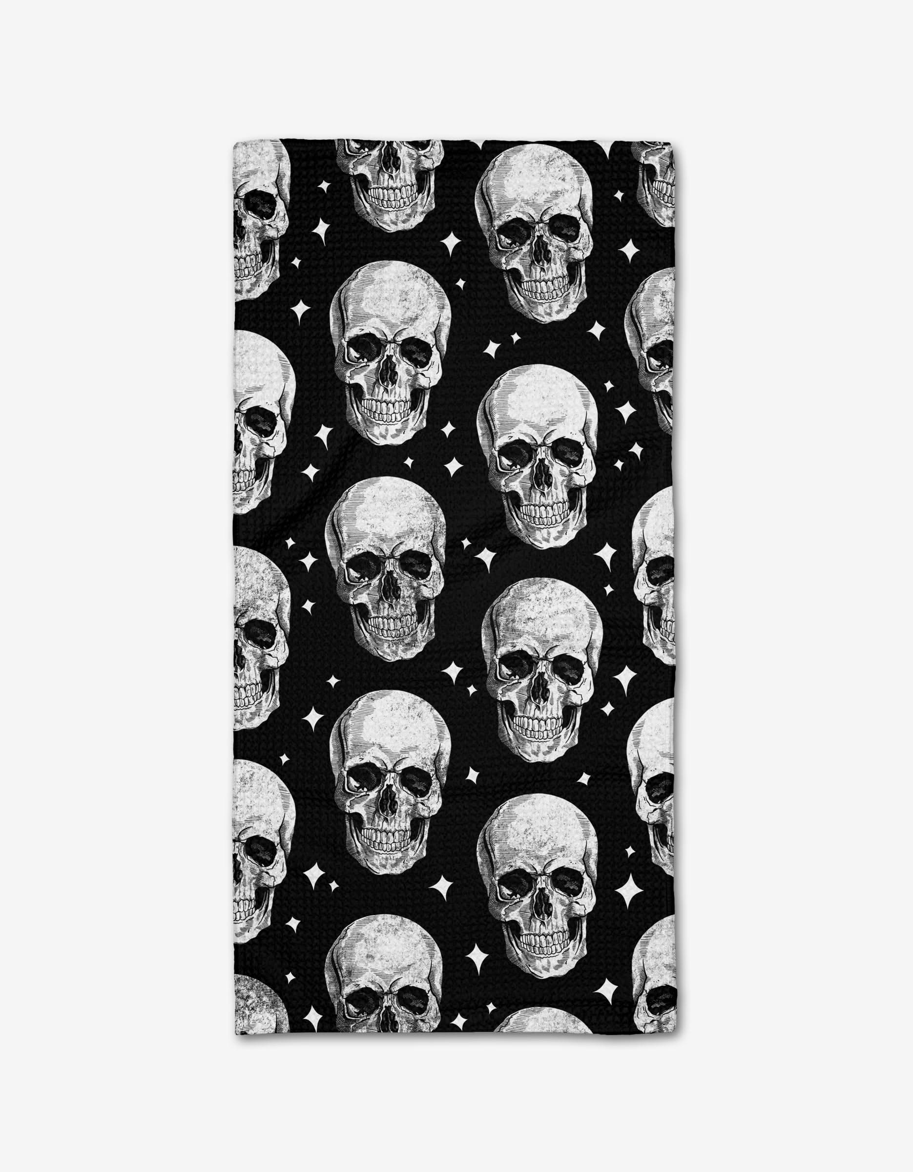 The Skulls bar towel by GEOMETRY is black, rectangular, and made from ultra-absorbent Geoweave fabric, featuring a bold white skull and diamond star pattern set against the dark background.