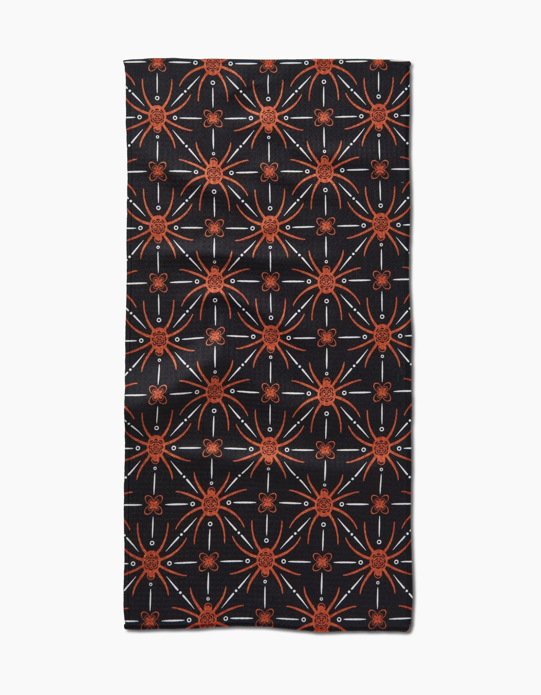 The Spider Geometric bar towel by Sarah Daugherty features ultra-absorbent fabric and a symmetrical, geometric pattern of orange starburst and floral motifs on black, making it a stylish addition to any kitchen or bar.