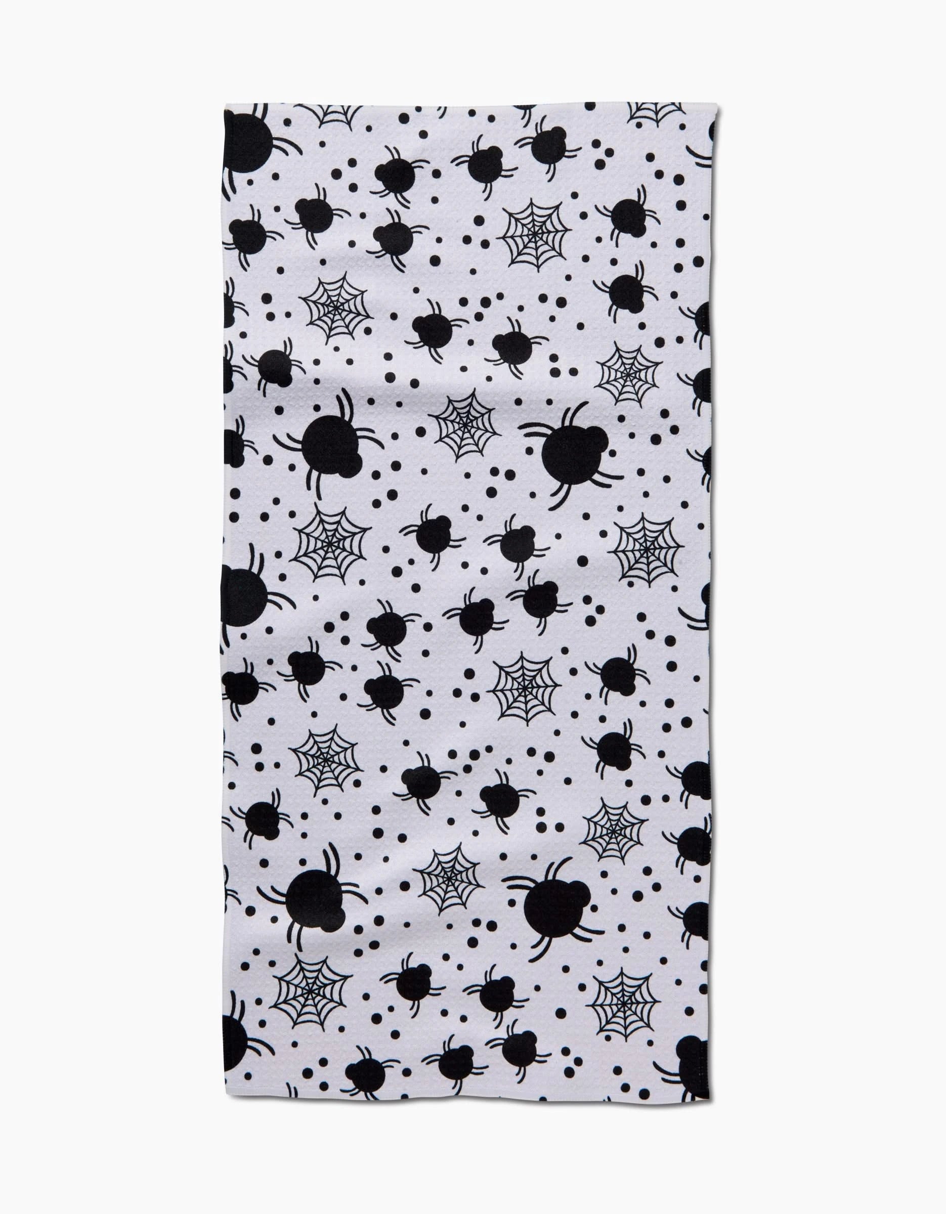 The Spiders For Days bar towel by Charlie Rowan Designs is a rectangular white towel with black spiders, spiderwebs, and dot patterns, made from recycled materials.