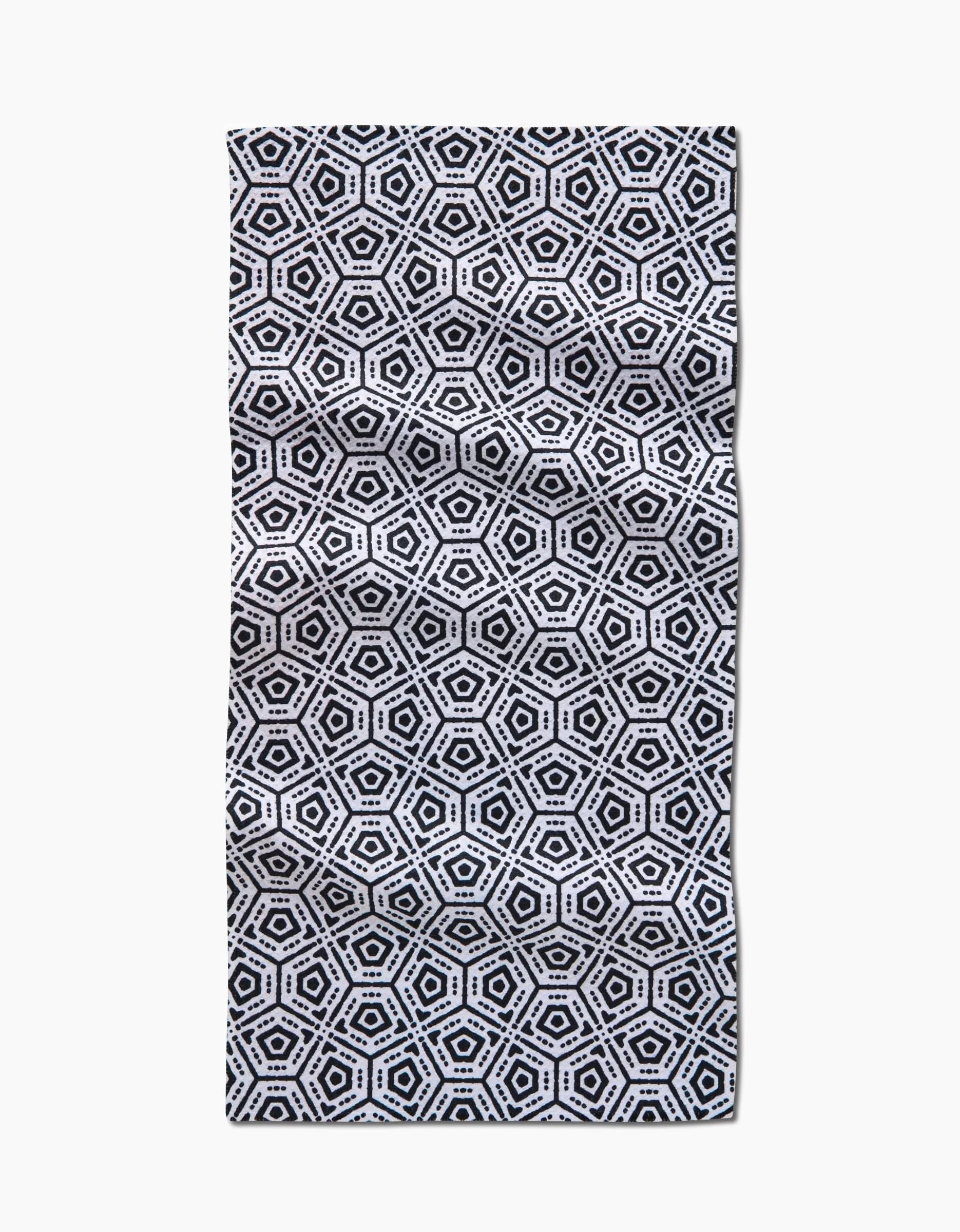 The Squeezebox Bar Towel by Katherine Berkeley showcases a repeating black and white hexagonal geometric pattern with concentric shapes and small dots, all crafted from durable Geoweave™ fabric for a striking, symmetrical look.