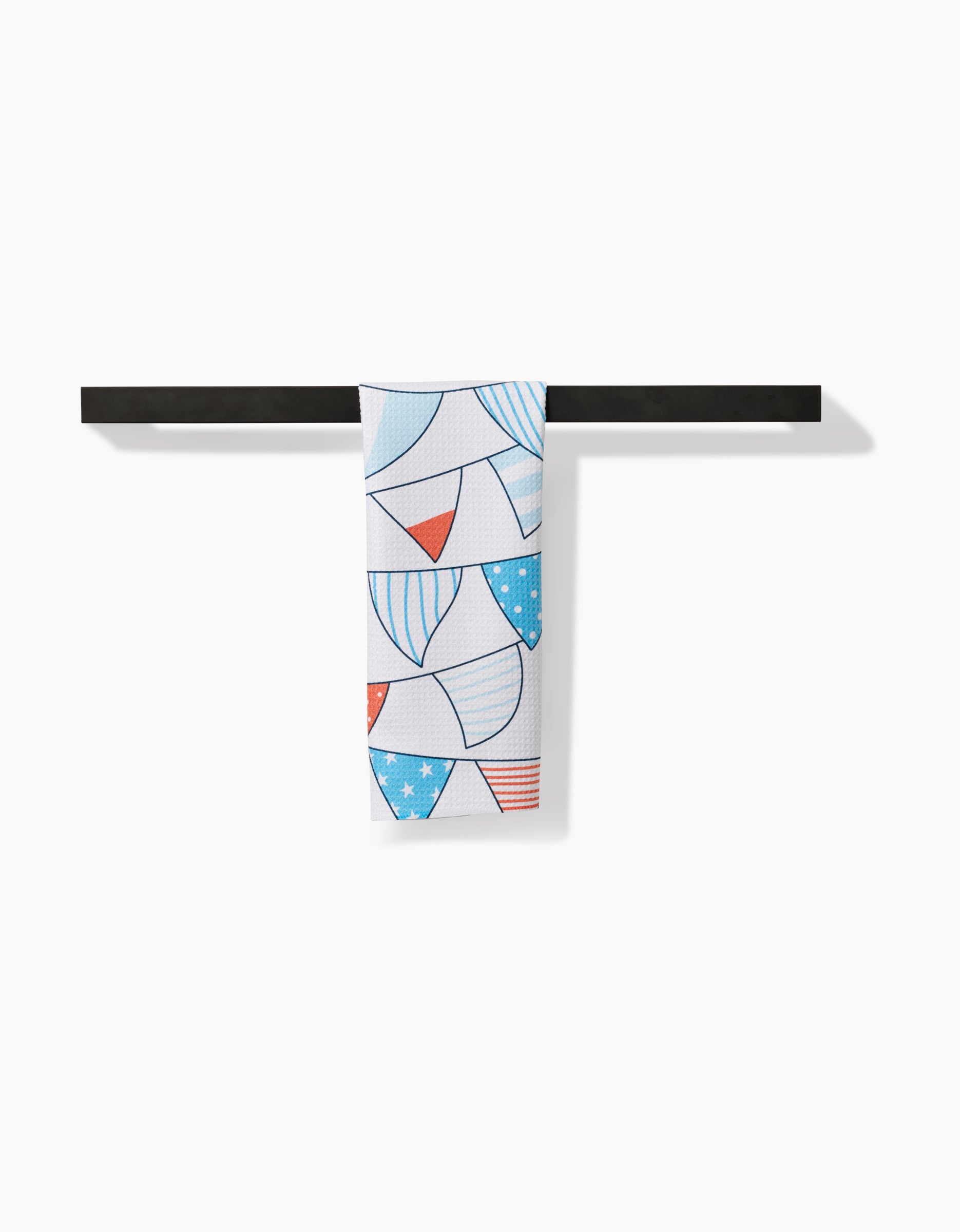 The Sara Mari Stars Stripes And Dots Bar Towel, crafted from durable Geoweave™ fabric for superior absorbency and quick drying, features a red, white, and blue bunting pattern and hangs over a black bar against a plain white background.