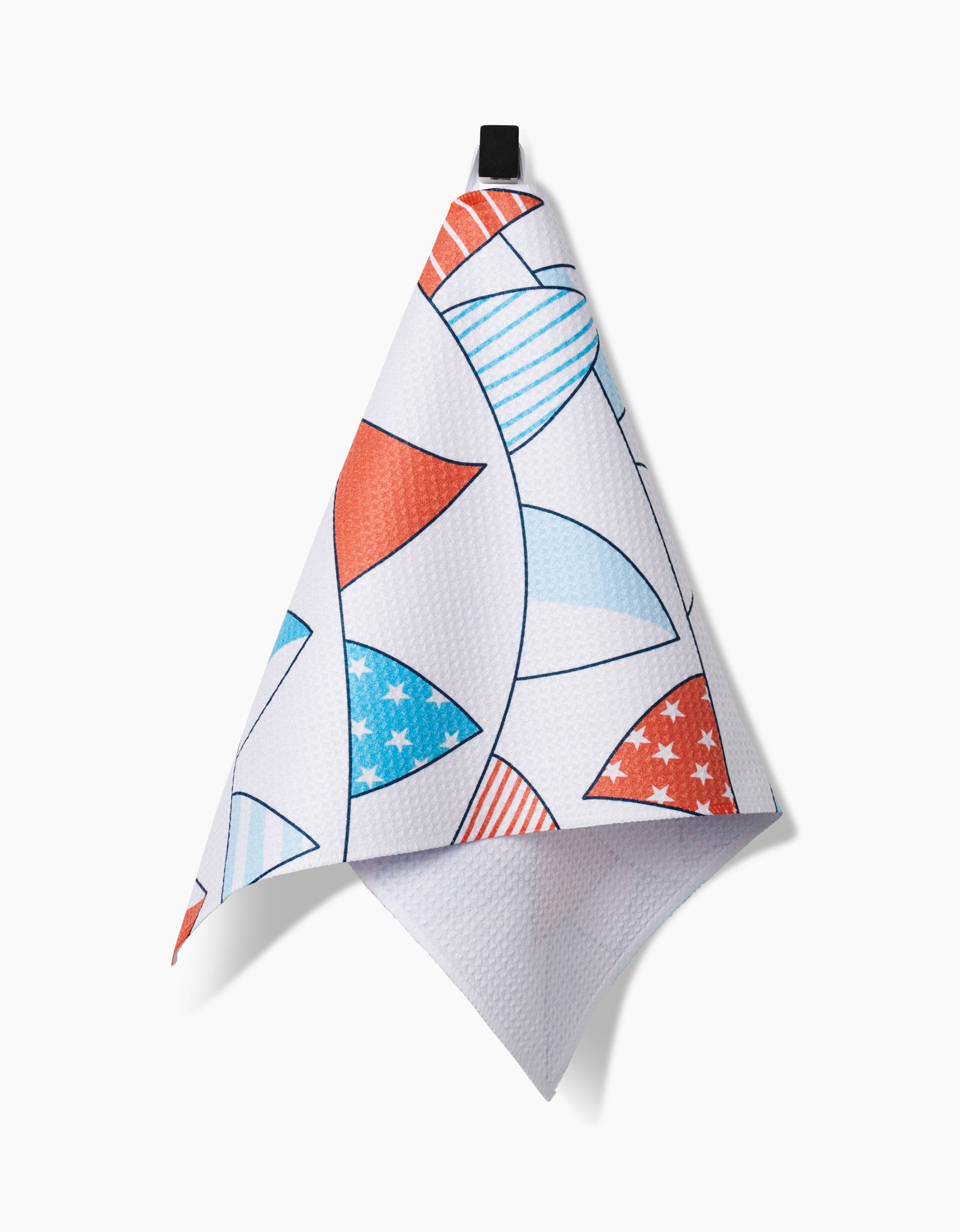 The Sara Mari Stars Stripes And Dots Bar Towel, made from Geoweave™ fabric, features red and blue sail shapes with stripes and stars. It hangs from a black loop against a plain white background.