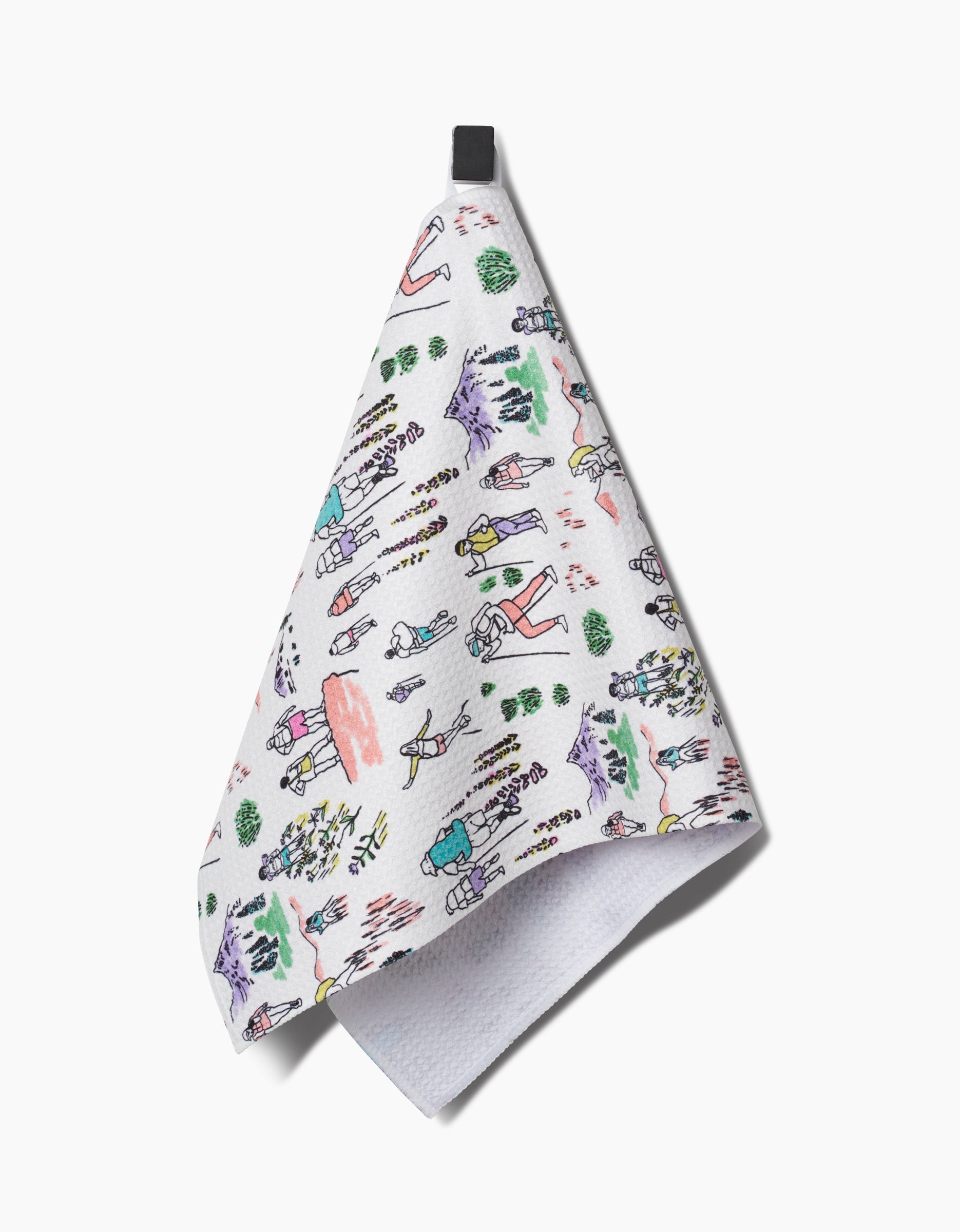 The Elisabeth Wing Take A Hike bar towel features colorful, playful drawings of hikers, trees, mountains, and animals on ultra-absorbent Geoweave fabric, with a black hanging loop on a white background.
