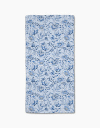 The Sara Mari Tea Set Blossoms bar towel features a blue floral pattern with various flowers and leaves on a light blue Geoweave fabric, shown flat against a white background.