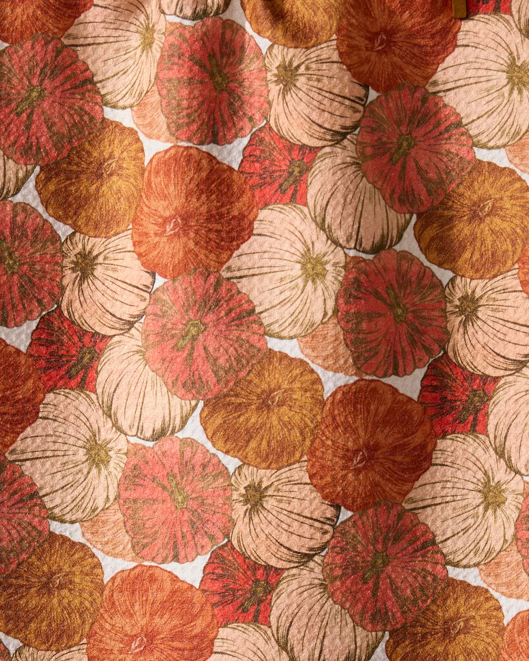 Geometry’s Tendril towel features a harvest-inspired pattern of overlapping orange, cream, and brown pumpkins with textured lines, creating an autumn look thats perfect for this ultra-absorbent towel.