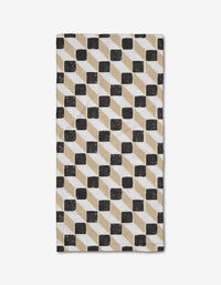 The Tessera Bar Towel by Studio Jeannot showcases a geometric pattern of black, beige, and white parallelograms and squares on a white background, made from recycled materials.