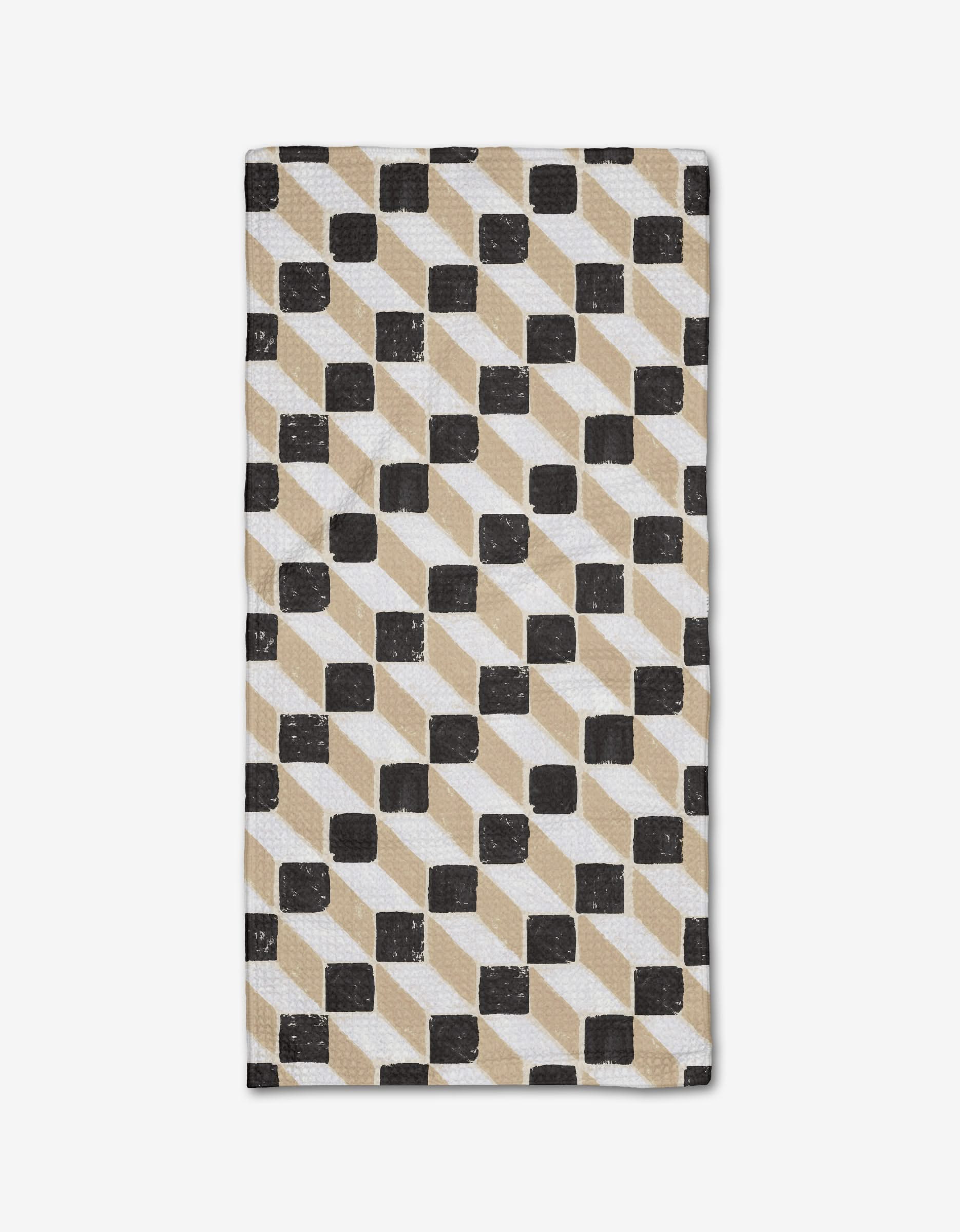 The Tessera Bar Towel by Studio Jeannot showcases a geometric pattern of black, beige, and white parallelograms and squares on a white background, made from recycled materials.