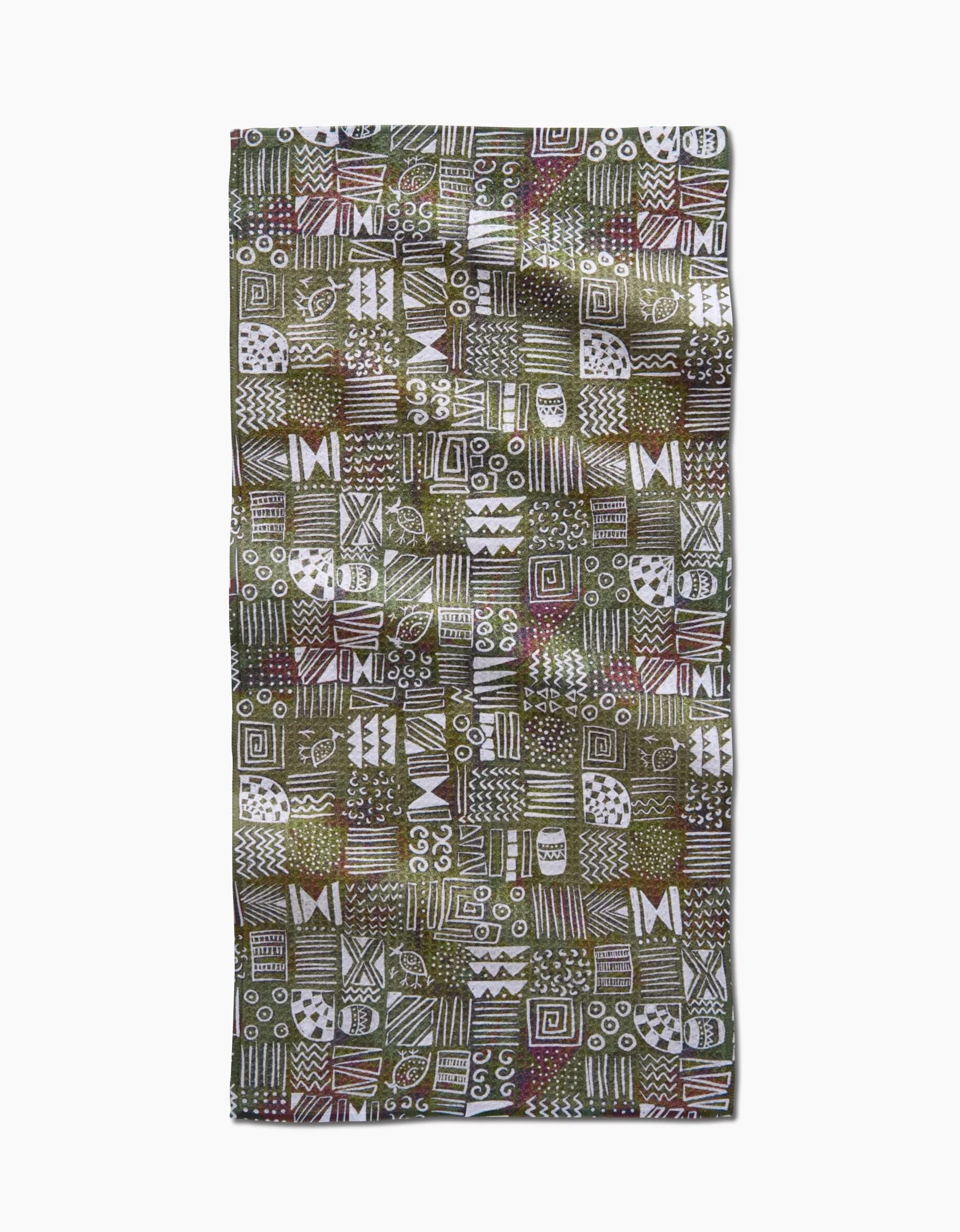 The Tribal Symbols bar towel by Taryn Brennan features eco-friendly Geoweave fabric with a green background and hand-drawn white, brown, and red geometric patterns arranged in a bold grid.