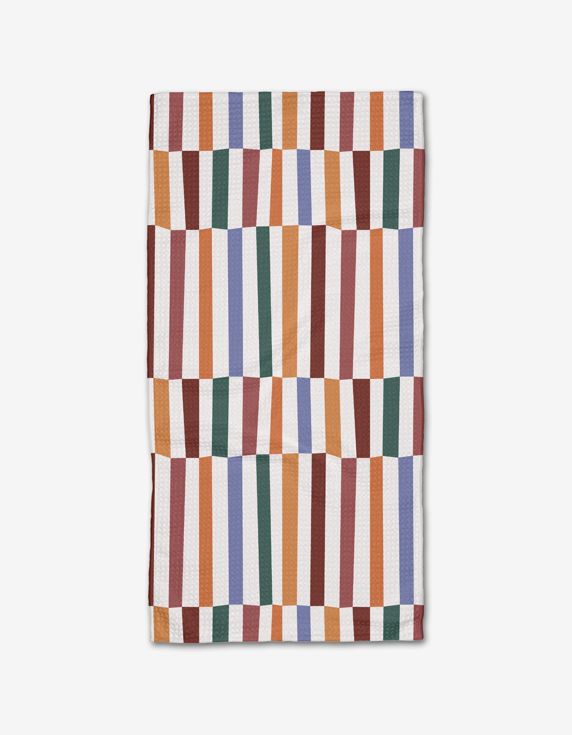 The Claire Iglesias Wonky Stripes Bar Towel features a geometric pattern of vibrant orange, red, green, blue, and white stripes on a plain background, crafted from recycled materials.