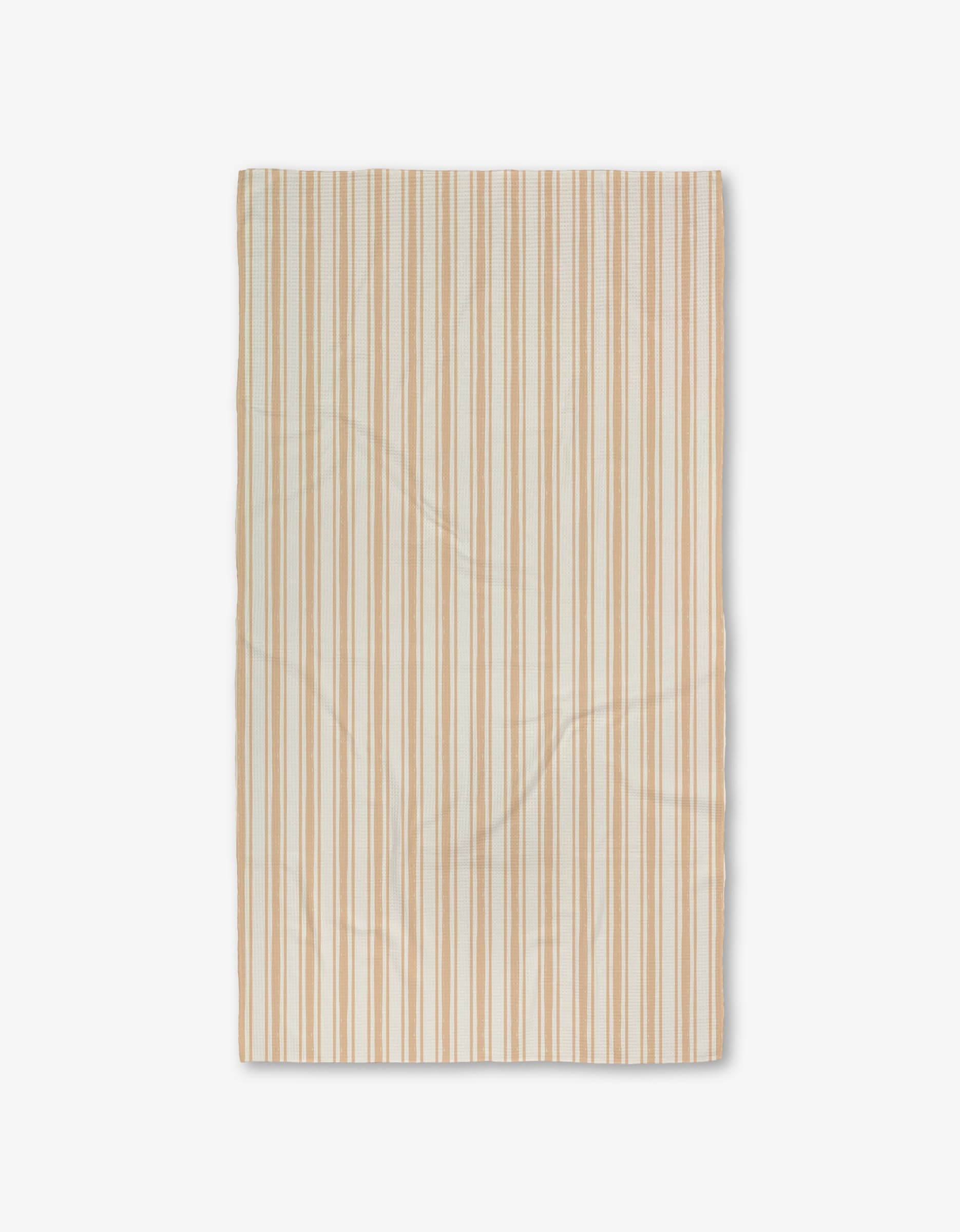 The Boho Stripe Luxe Bath Towel by Hufton Studio is a rectangular beige towel with thin tan and light brown stripes, featuring ultra-absorbent Geoweave fabric. It is shown flat on a white background with subtle texture and slight creases.