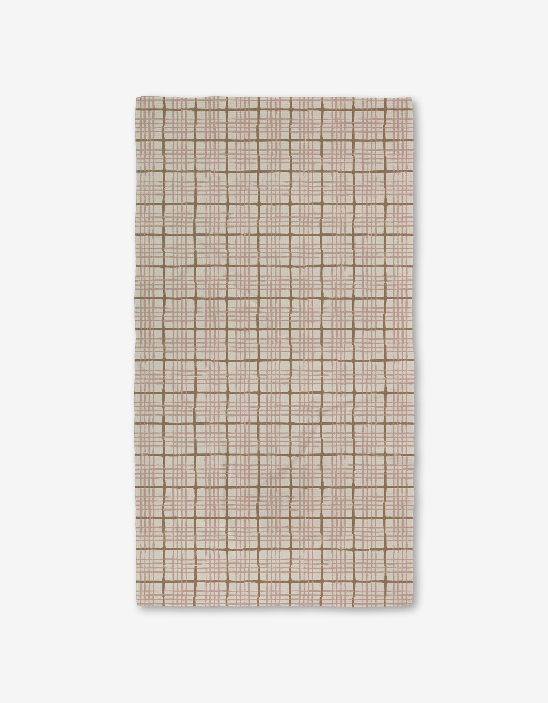 The Crossover by Studio Jeannot is a rectangular beige textile featuring a grid of light brown and white lines with small square and rectangular accents. Made with Geoweave technology, it offers a soft, textured, and highly durable surface.