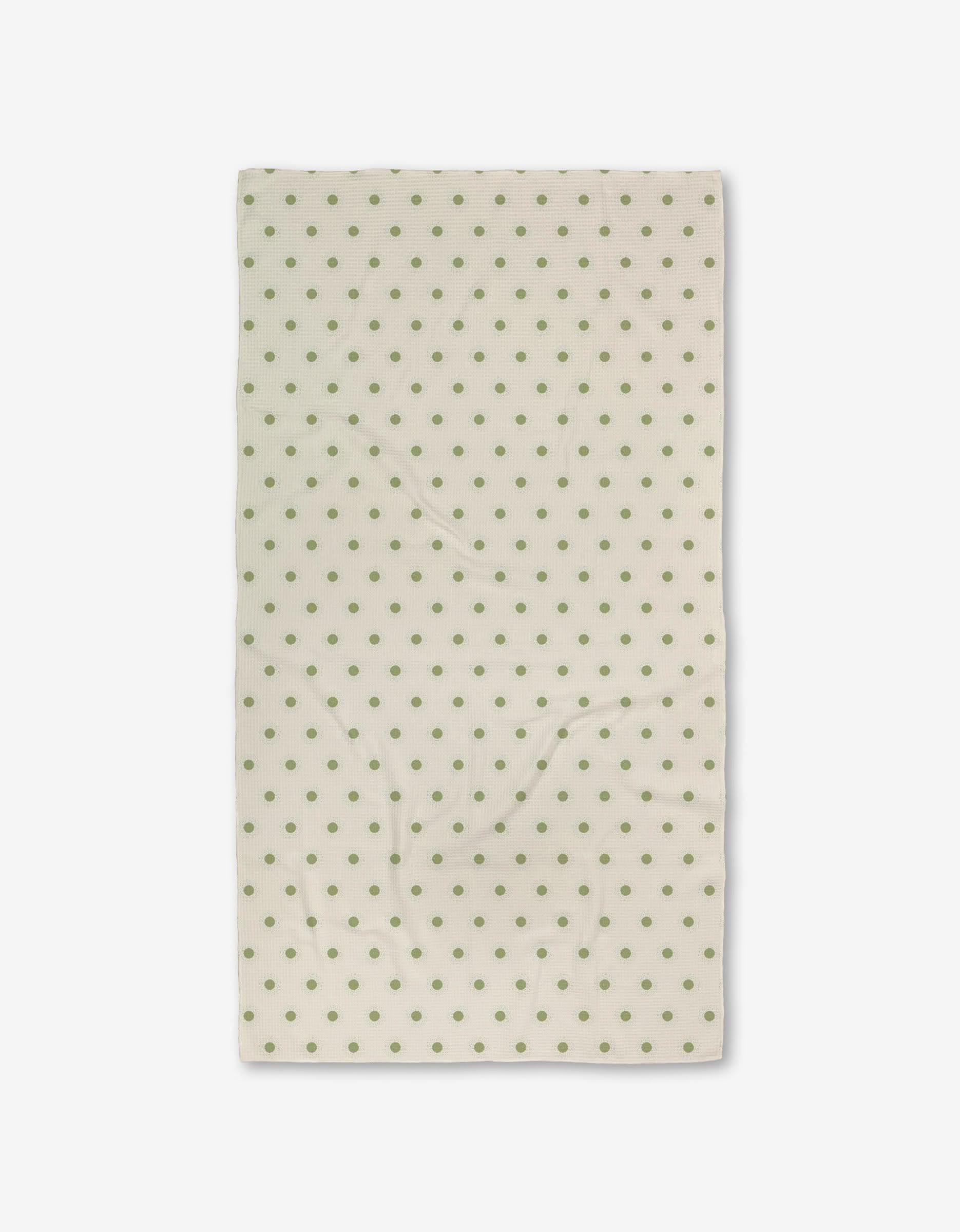 The Sunshine Glow by Danelys Sidron is a cream-colored rectangular cloth with evenly spaced green polka dots, made from recycled materials, displayed flat against a white background.