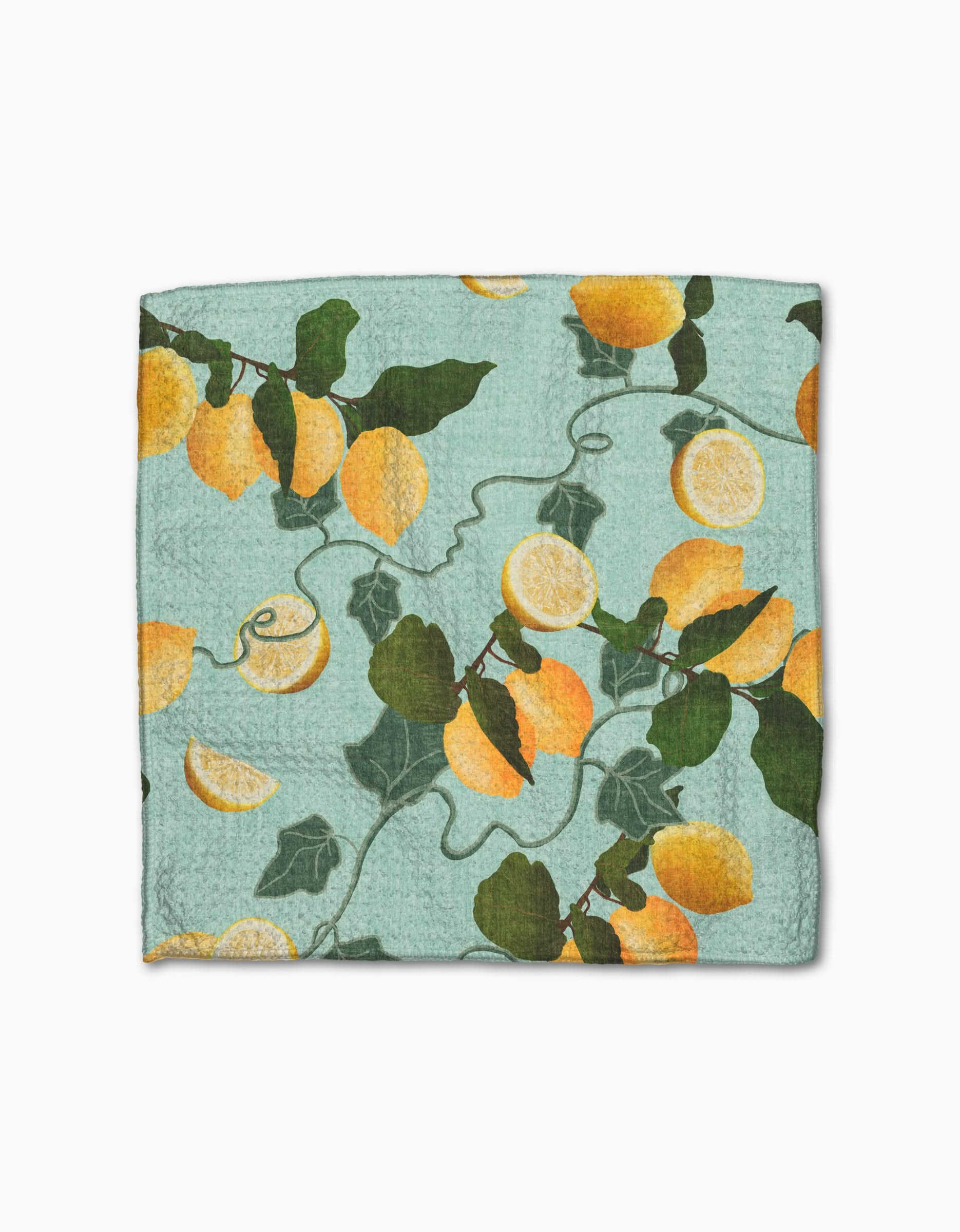The Amalfi Lemon dishcloth by Pascale Dilger is blue, made from recycled materials, and features yellow lemons, lemon halves, and green leaves with vines.