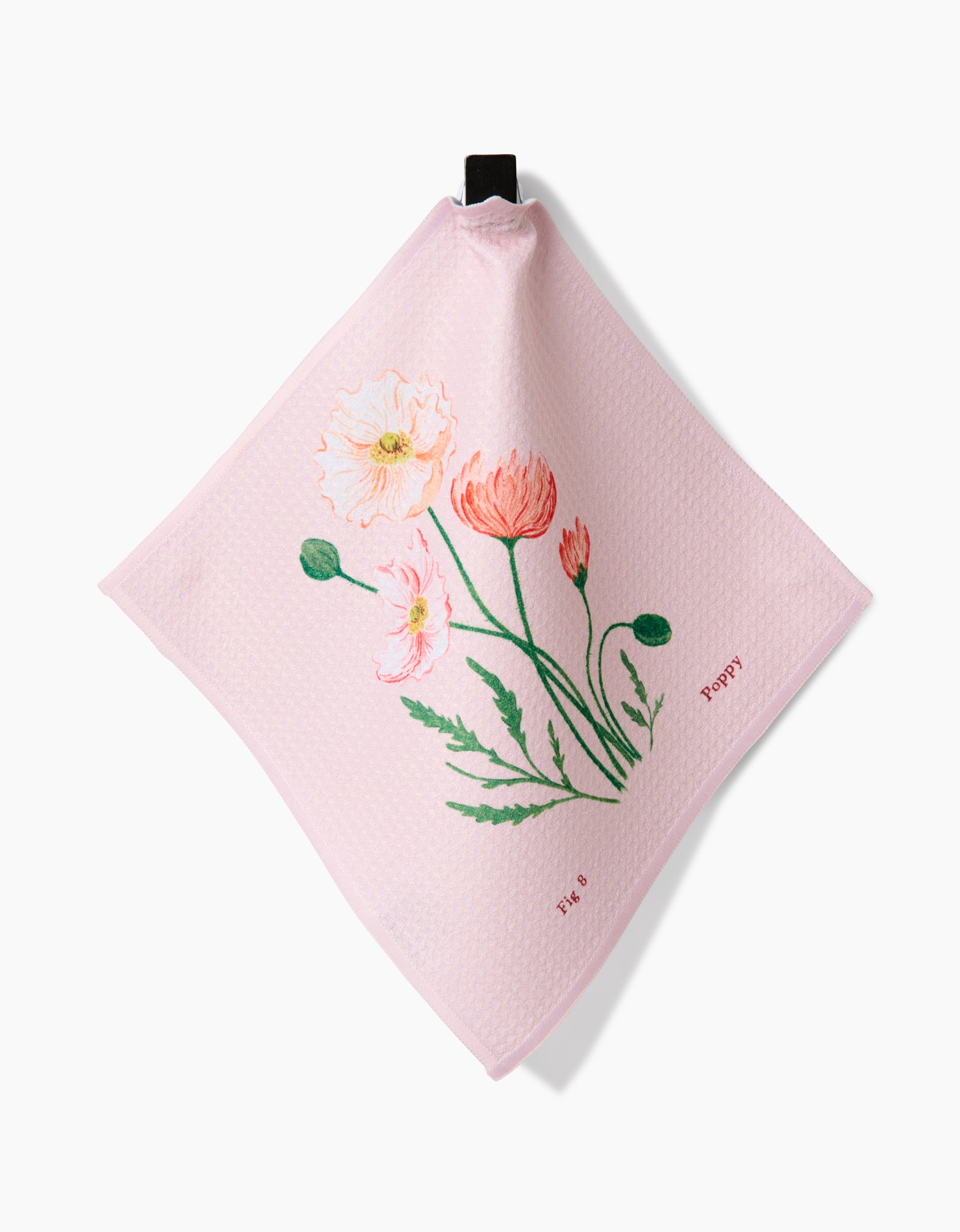 The August Poppy dishcloth by Linda Fox is pink and textured with Geoweave fabric, featuring poppy flowers and green leaves. Poppy and Tate are printed near the bottom right, with a black hanging loop at the top.