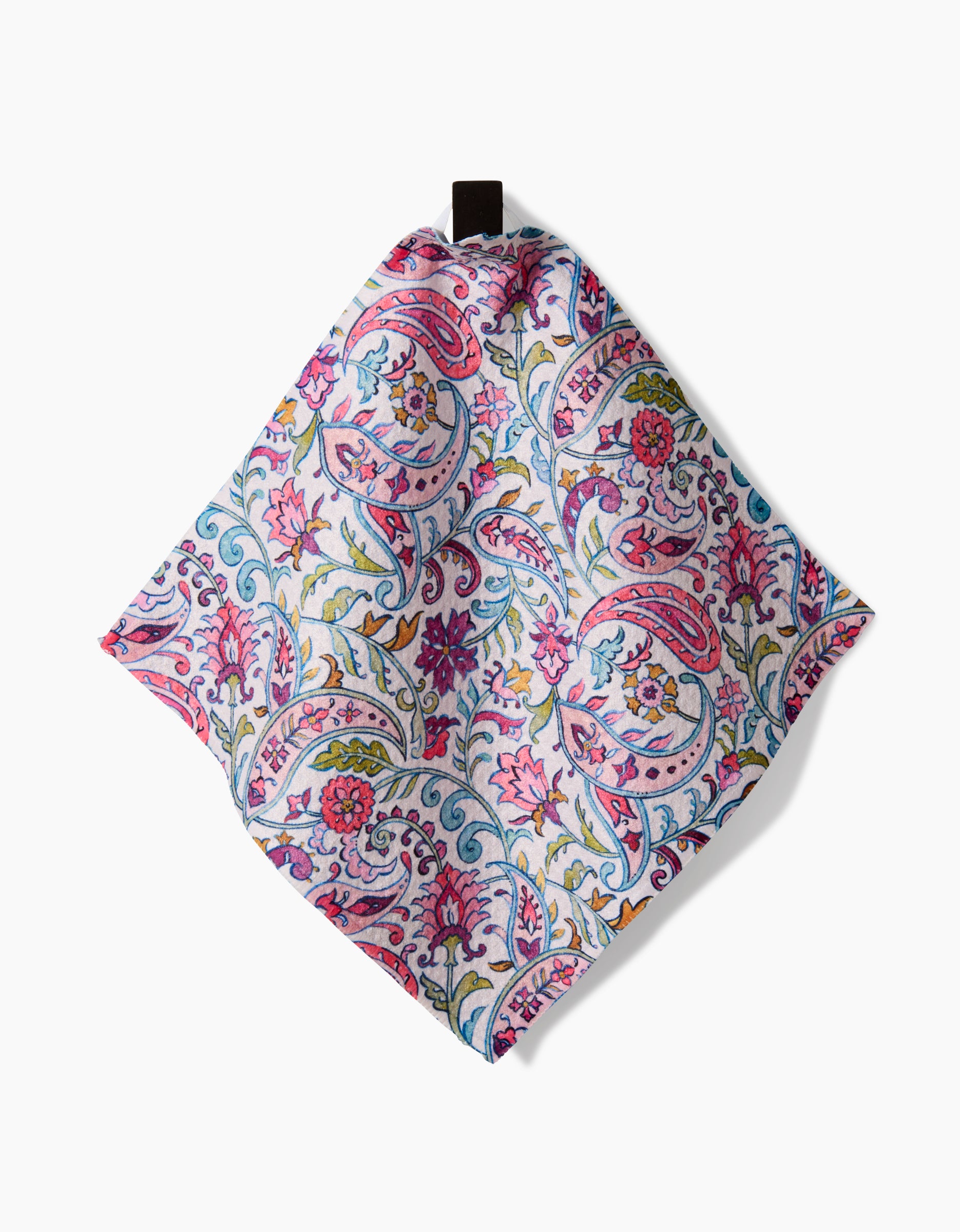 Bazaar by Maayan Alper-Swan: a square cloth napkin crafted from Geoweave fabric, featuring a vibrant floral paisley print in pink, blue, green, and red on white with a black hanging loop at one corner.