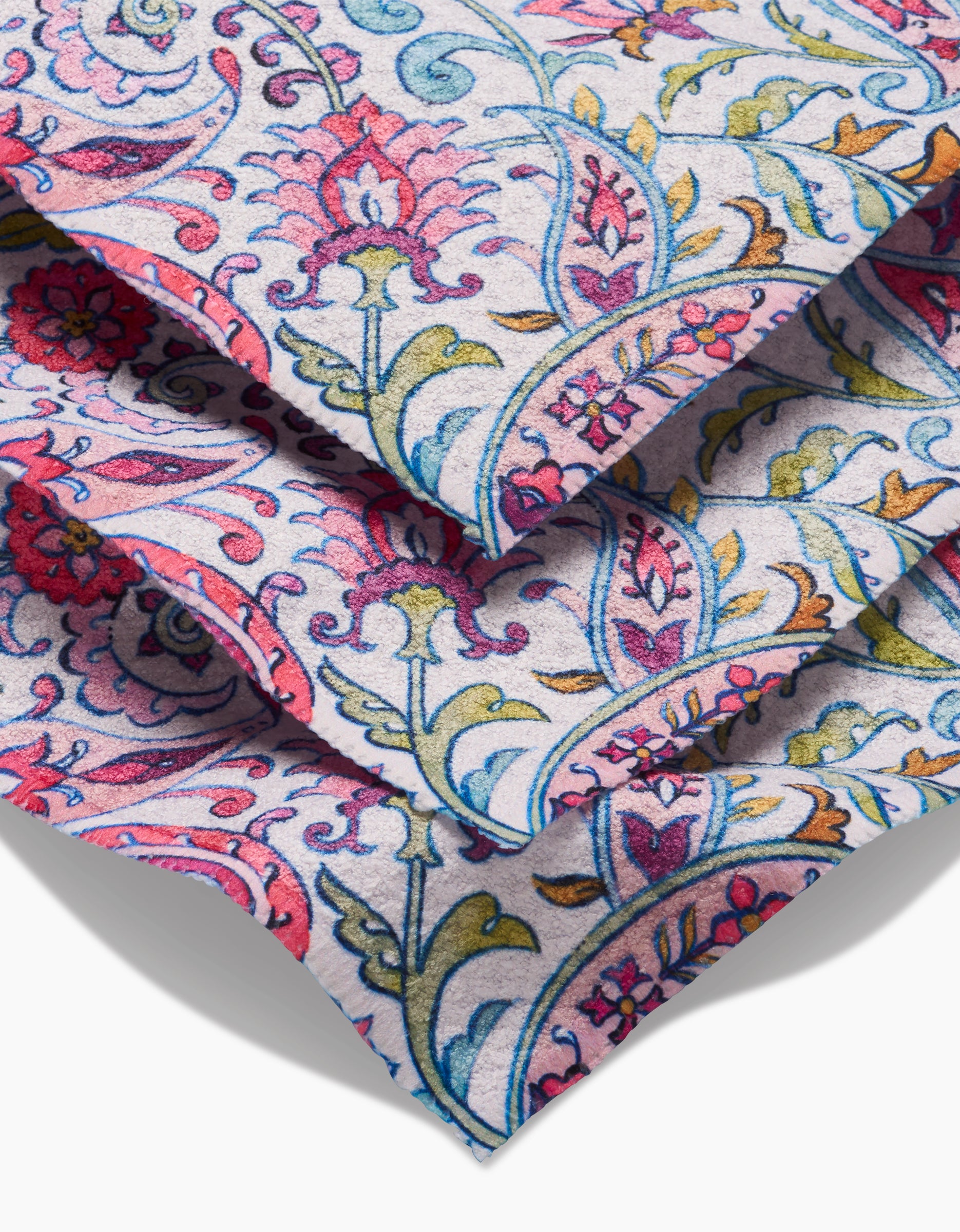 Bazaar dishcloths by Maayan Alper-Swan are crafted from sustainable Geoweave fabric and feature a vibrant floral and vine pattern in pink, blue, yellow, and green on a light background for decorative appeal.
