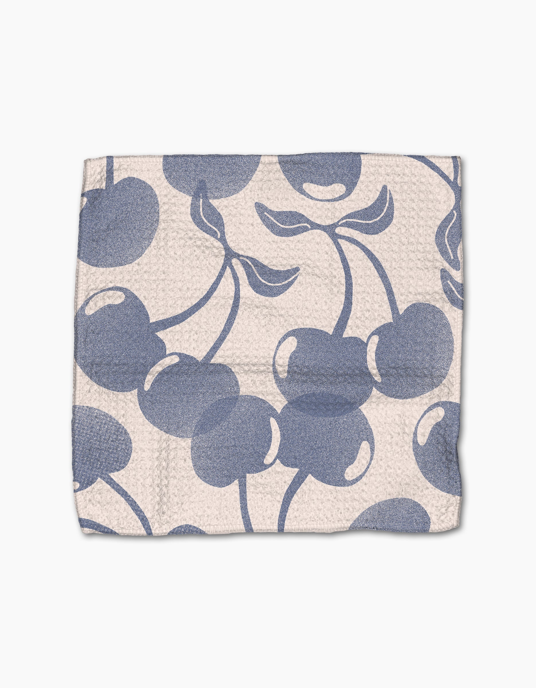 Blue Cherry Dreams by Geometry is a textured, off-white Geoweave cloth made from recycled materials, featuring large blue cherry and leaf patterns scattered across the surface.