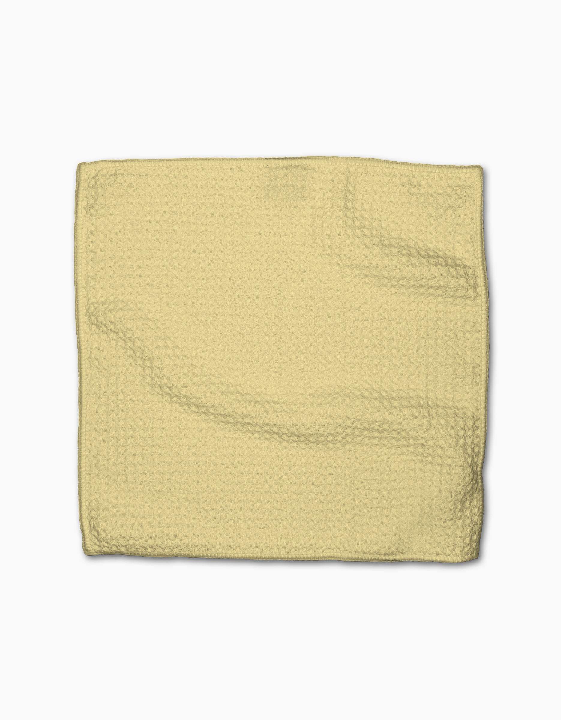 A folded GEOMETRY Butter Yellow dishcloth made from textured Geoweave fabric is laid flat on a white background.