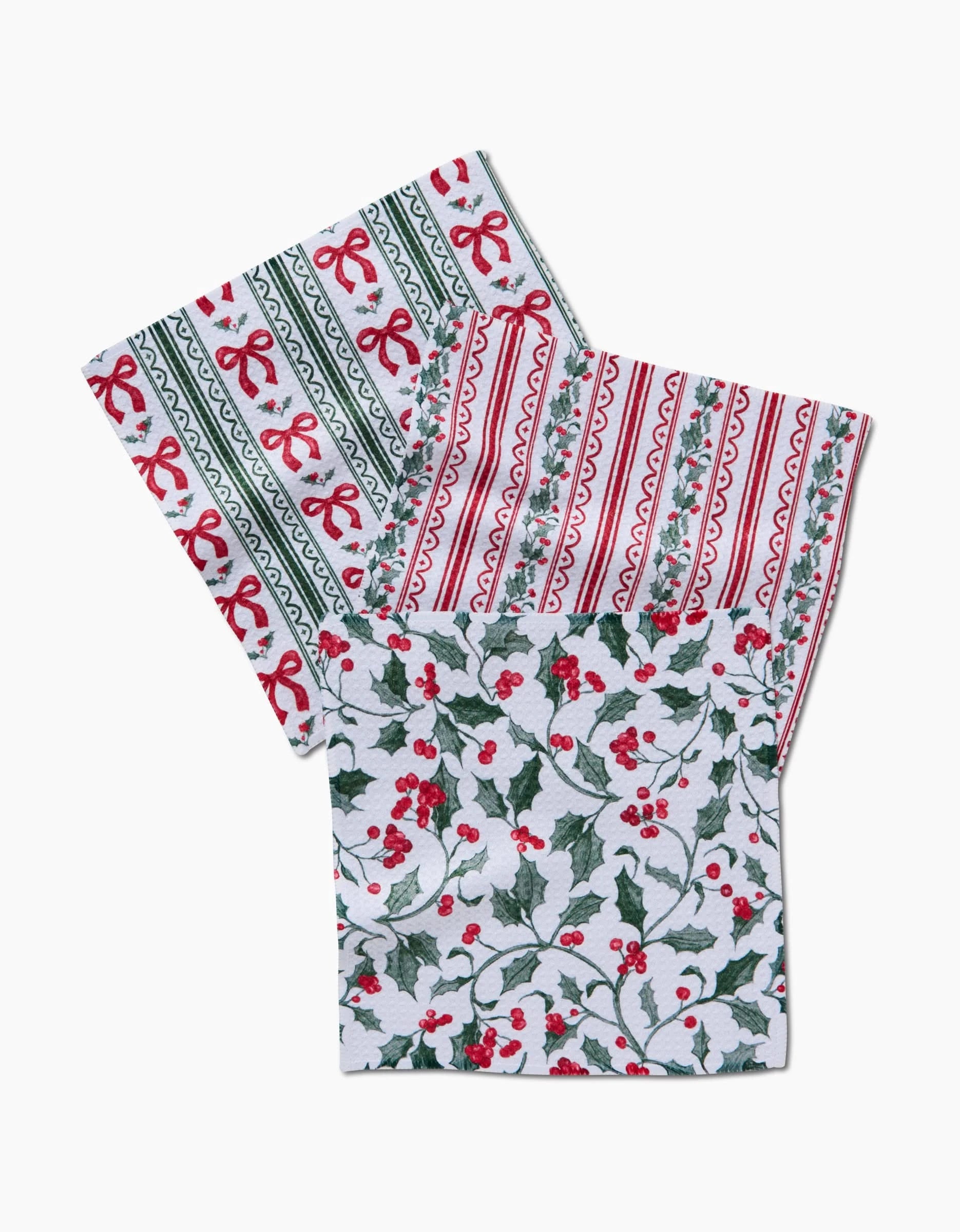 Aubrey Fairchild’s Christmas Ribbons set includes three Geoweave napkins, each with festive designs—red bows and stripes, holly and berries—all in a super-absorbent dishcloth style.