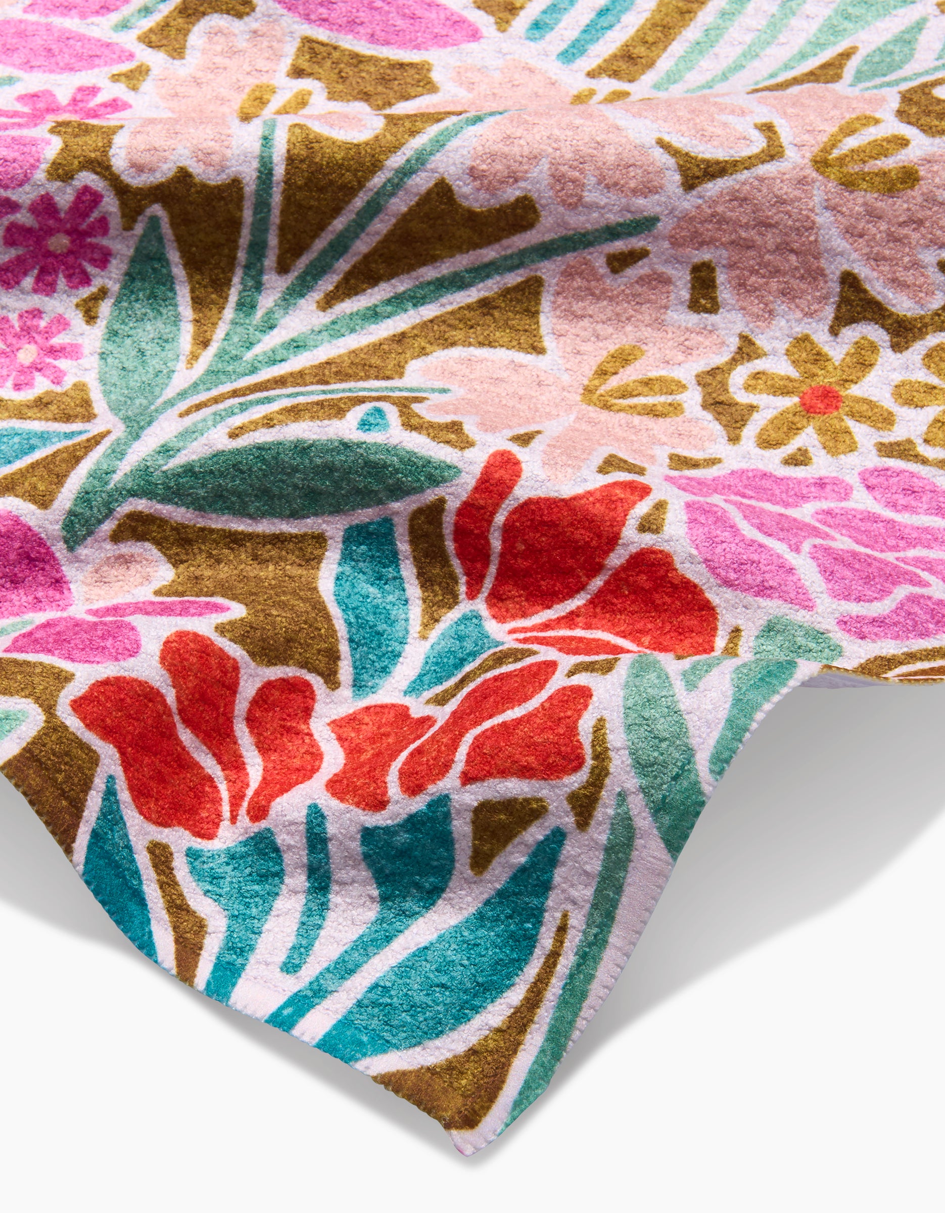 A close-up of Clemmie Donna and Janae by Amy MacCready shows bold pink, red, yellow, and green floral patterns on a brown Geoweave fabric background.