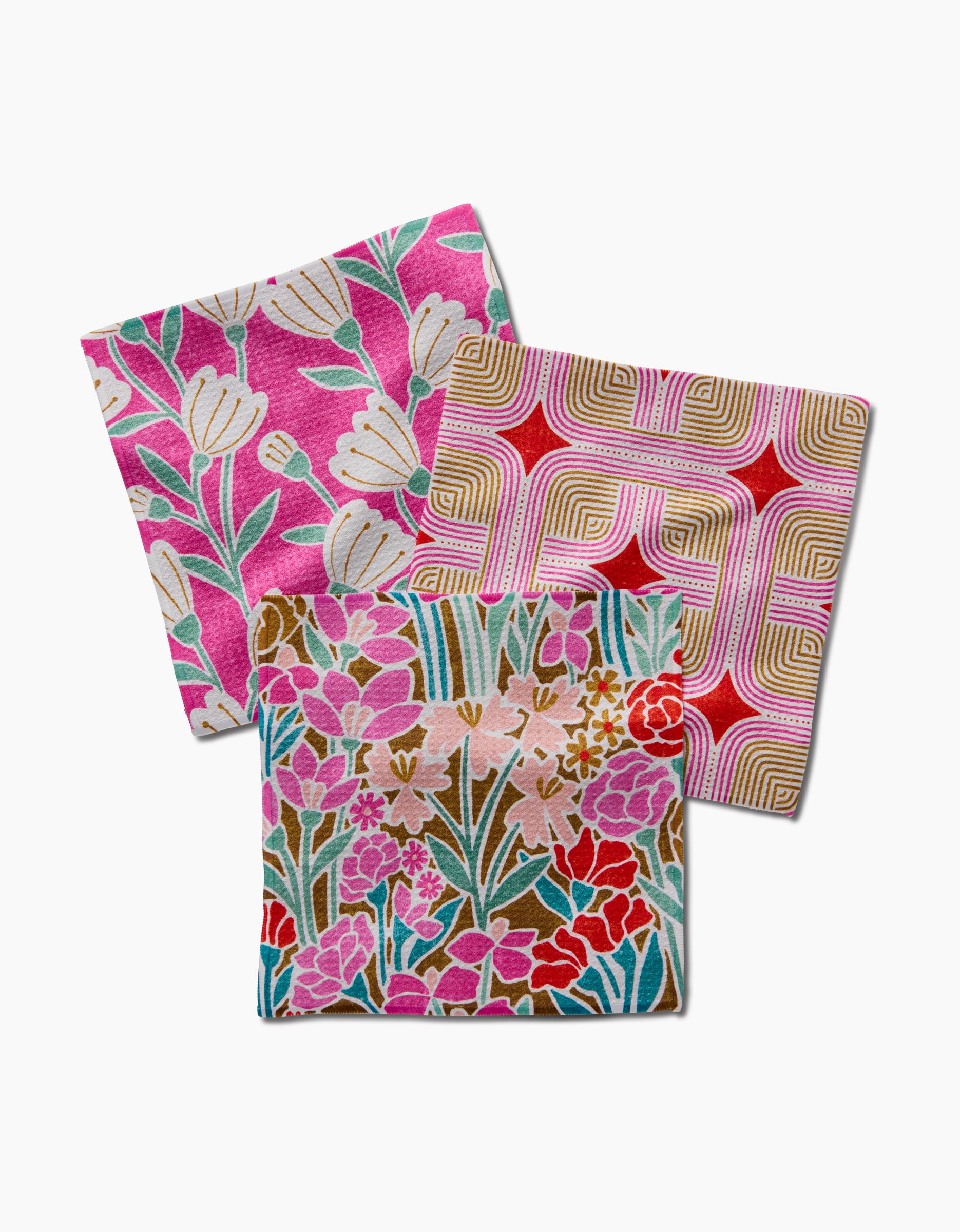 The Clemmie Donna and Janae set by Amy MacCready features three recycled-fabric squares in floral and geometric prints, overlapping on white—an eco-friendly dishcloth set.