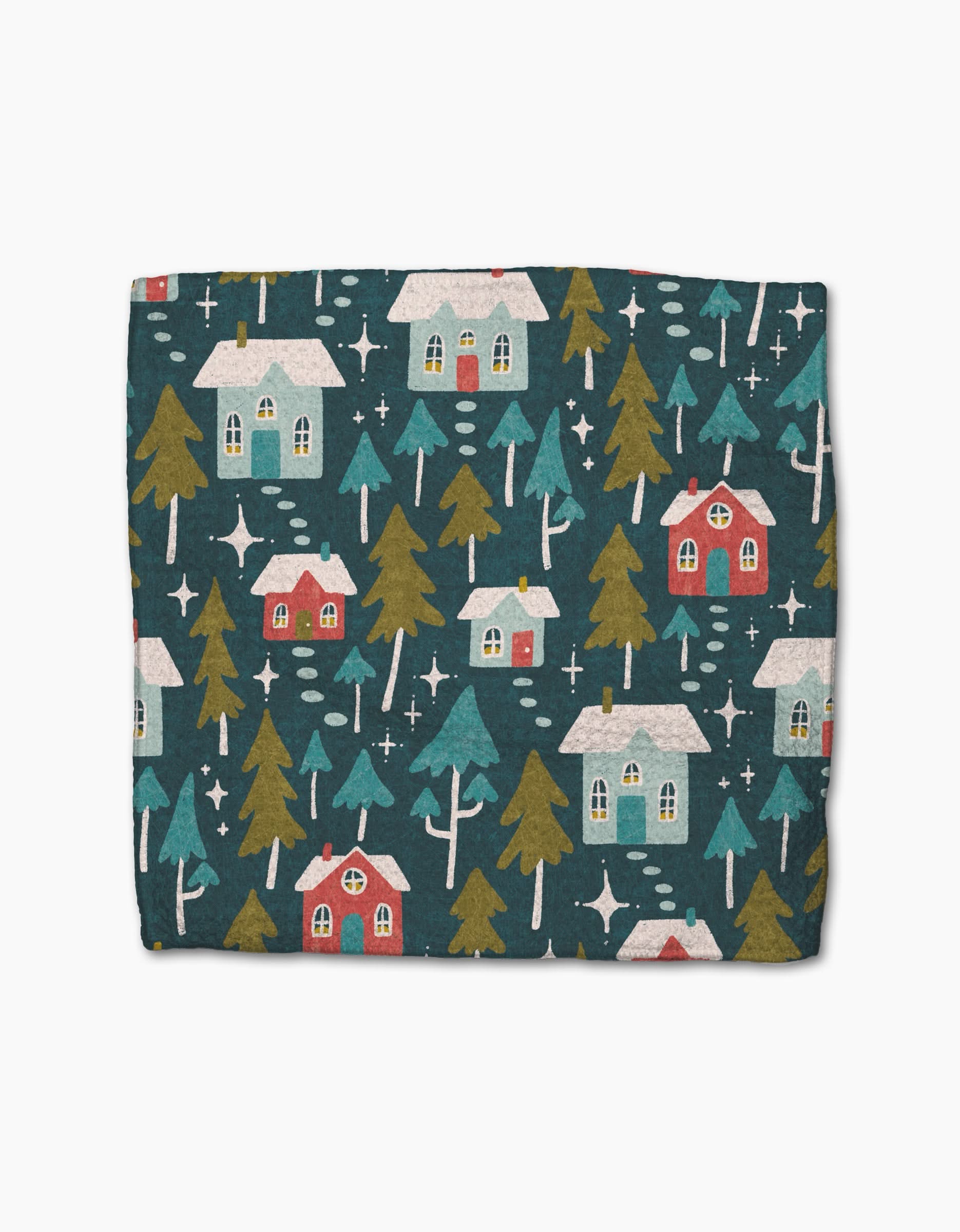 The Evervale blanket by Amy MacCready features a whimsical pattern of white and red snow-covered houses, green trees, and stars on a dark blue background. Crafted from recycled materials for a cozy, eco-friendly touch.