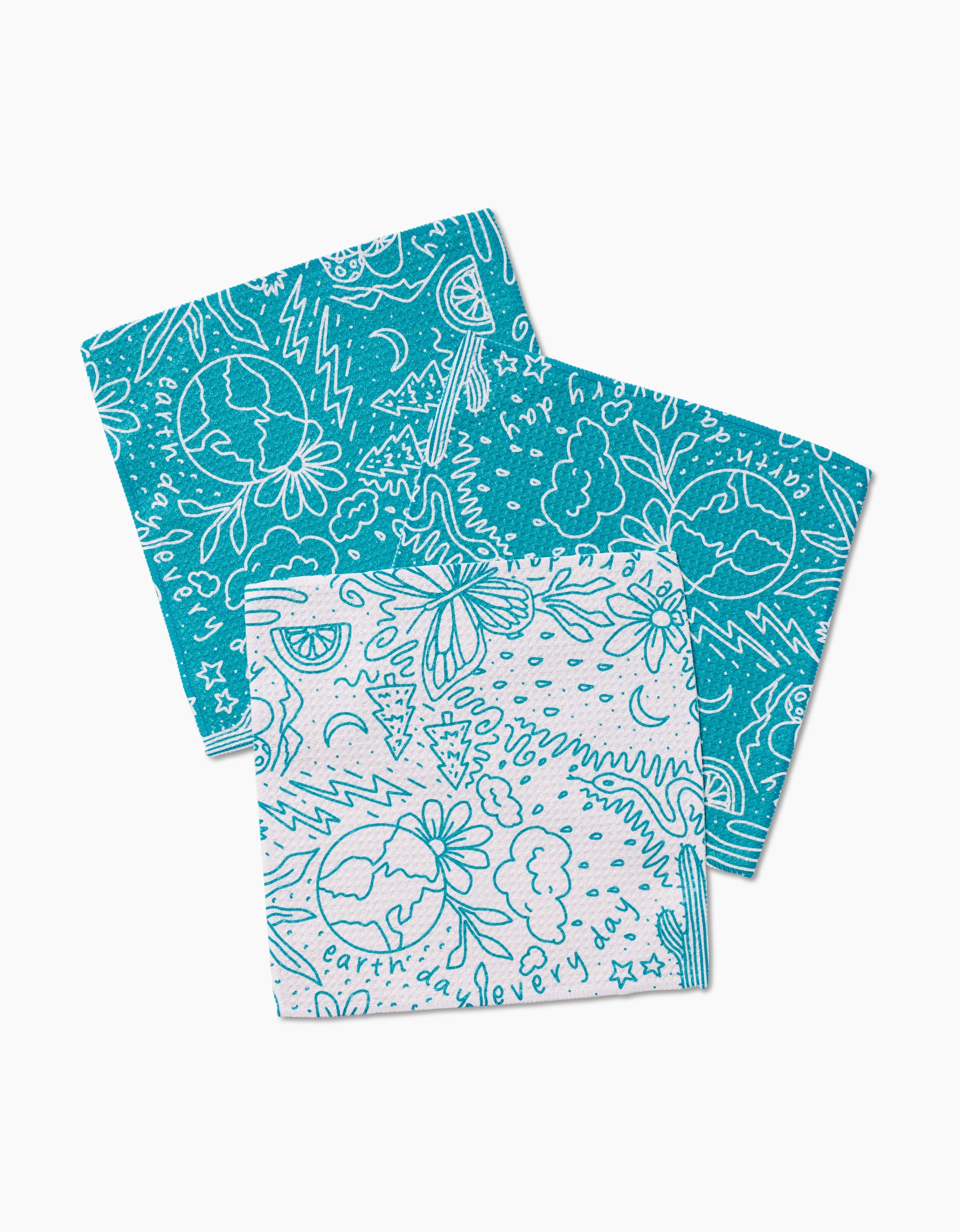 The GEOMETRY Every Day set includes two Swedish dishcloths made from recycled materials, featuring playful hand-drawn blue designs of clouds, flowers, and earth; one is white with blue designs, the other teal with blue designs.