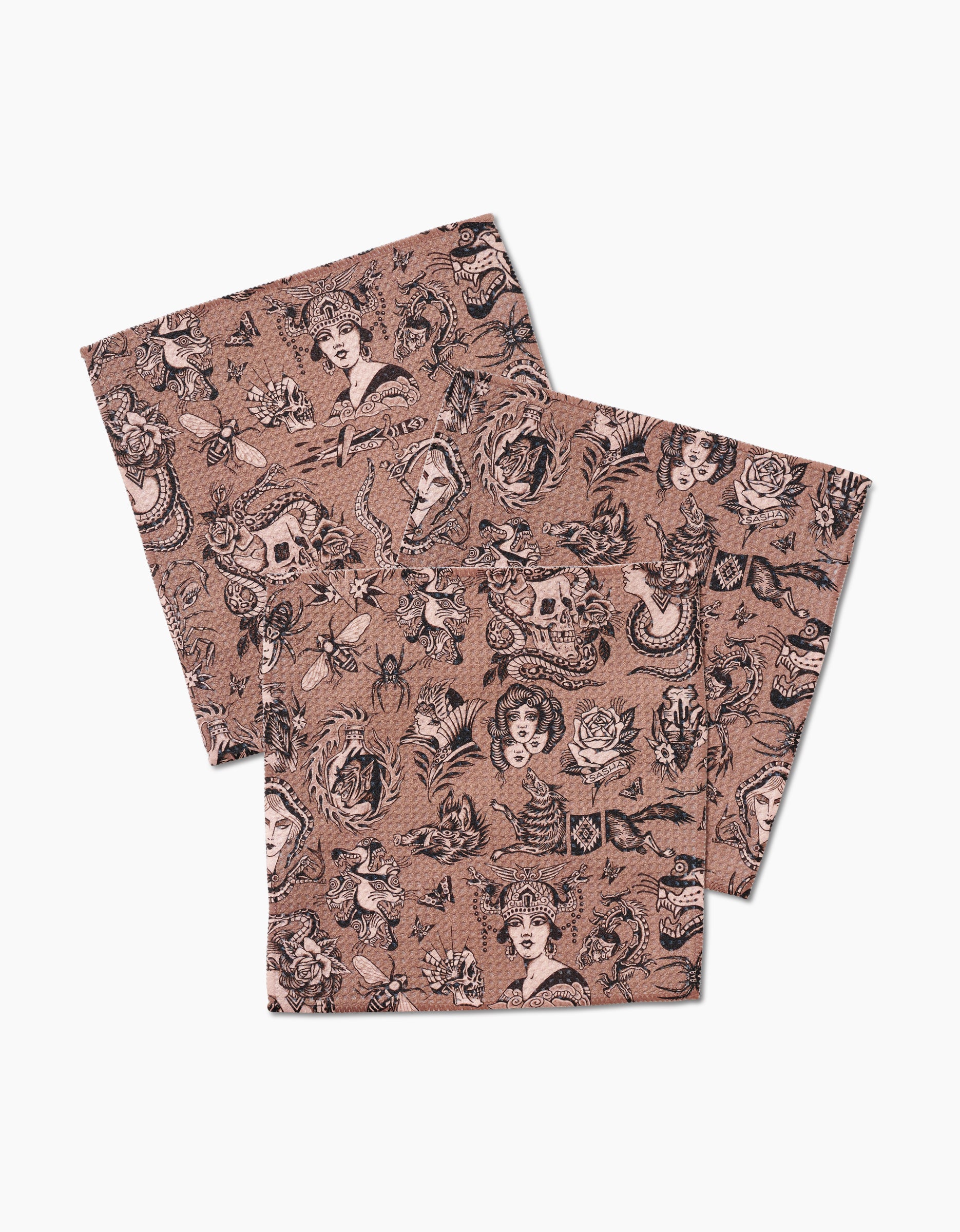 Three pink Geoweave fabric handkerchiefs from Cole Strem’s Flash collection, featuring black tattoo-style faces, roses, skulls, snakes, and florals on white. Crafted from recycled materials for a sustainable style.