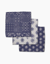 Three Flowing Ocean handkerchiefs by Geometry, crafted from Geoweave fabric for superior absorbency. Featuring patchwork, blue floral, and white floral patterns. All are neatly stacked and slightly overlapping.