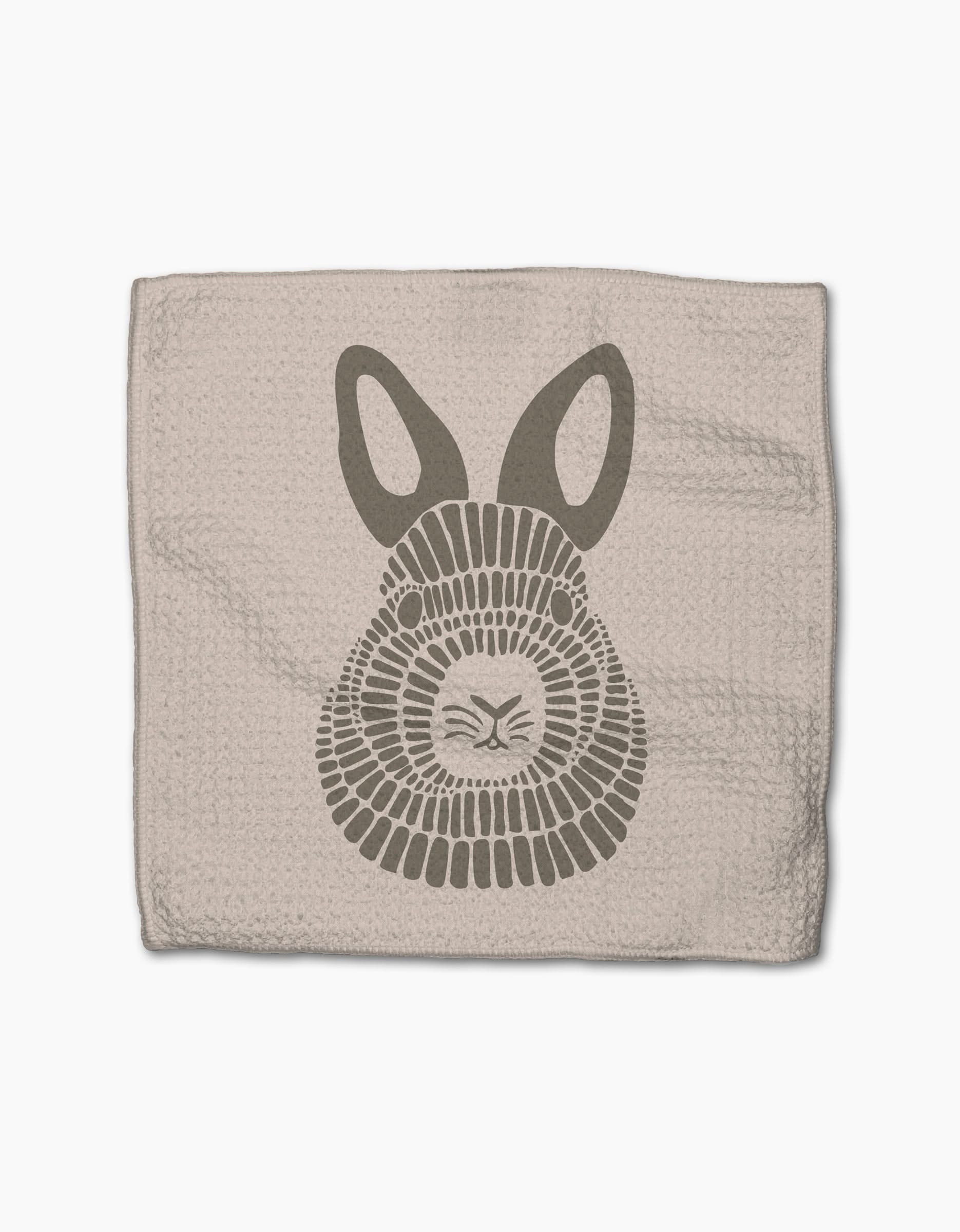 Forest Animals by Rosa Kichline: A beige textured cloth made from recycled materials, featuring a stylized gray bunny face with large ears and geometric fur, set against a white background.