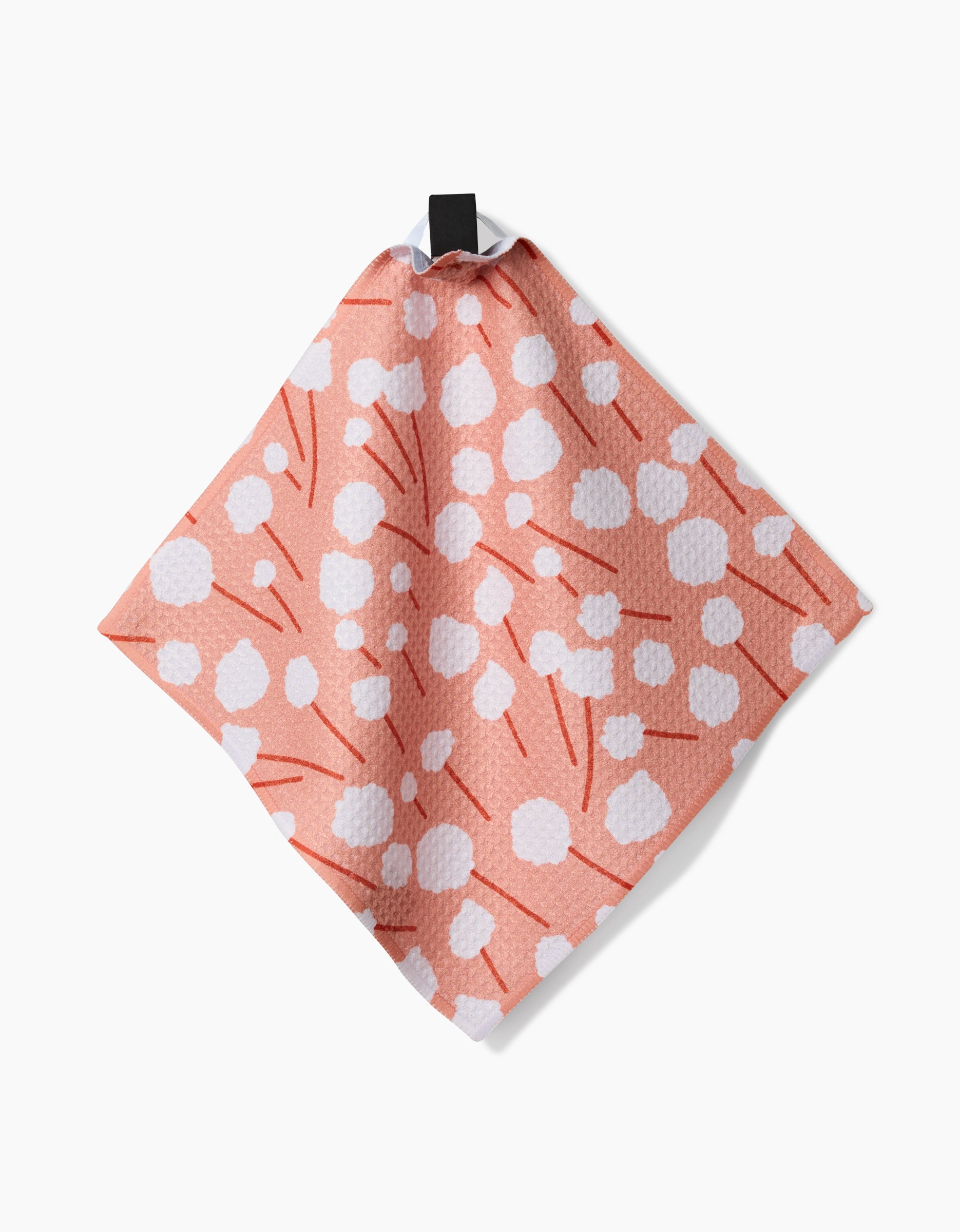 The Forest Florals dishcloth by Coit Creative features a pink textured design with white dots and red lines, made from recycled materials. It hangs by a black loop against a white background.