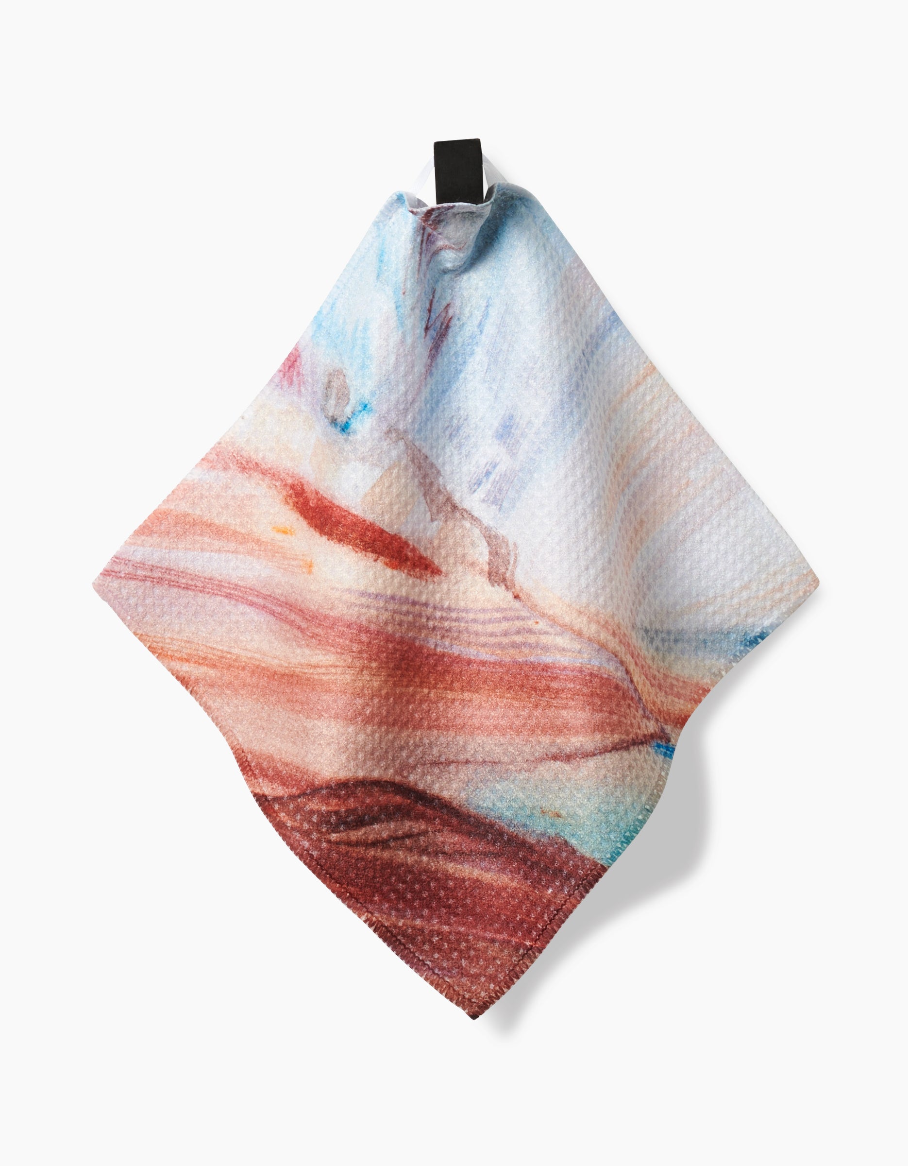 The “Golden Hour in the Rockies” dishcloth by Kelly Peters features a Geoweave textured fabric with an abstract red, blue, and white design, displayed hanging from a black loop against a white background.