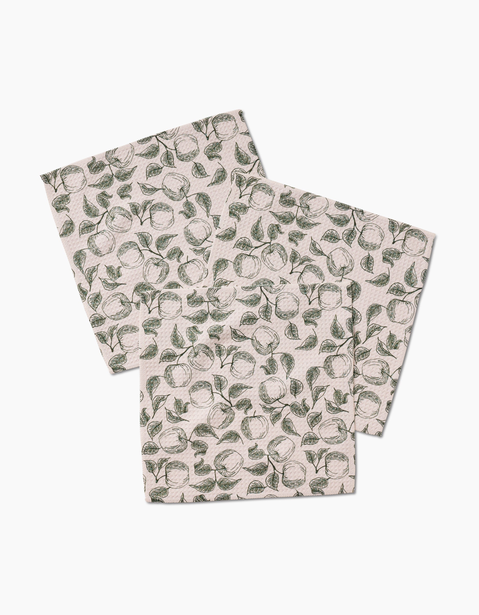 Three white Geoweave fabric napkins by Ash Cascade, featuring a red Gravenstein Apple pattern, arranged overlapping on a white background.