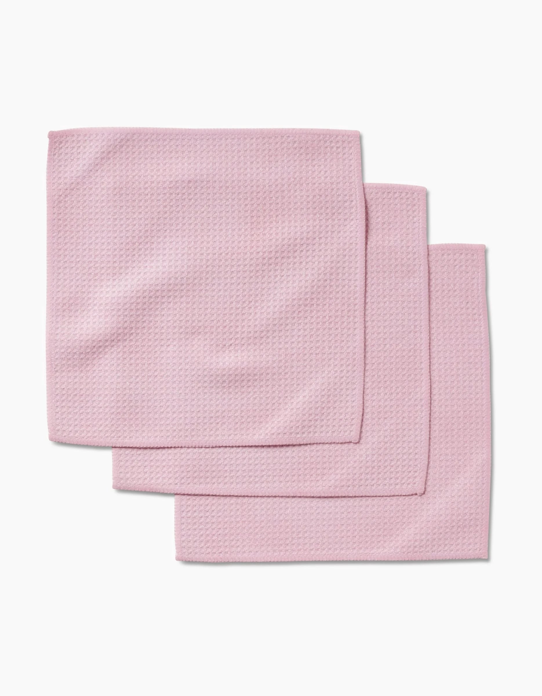 Three folded Harper Pink washcloths, made from Geoweave fabric, are stacked in a slightly overlapping arrangement on a white background.